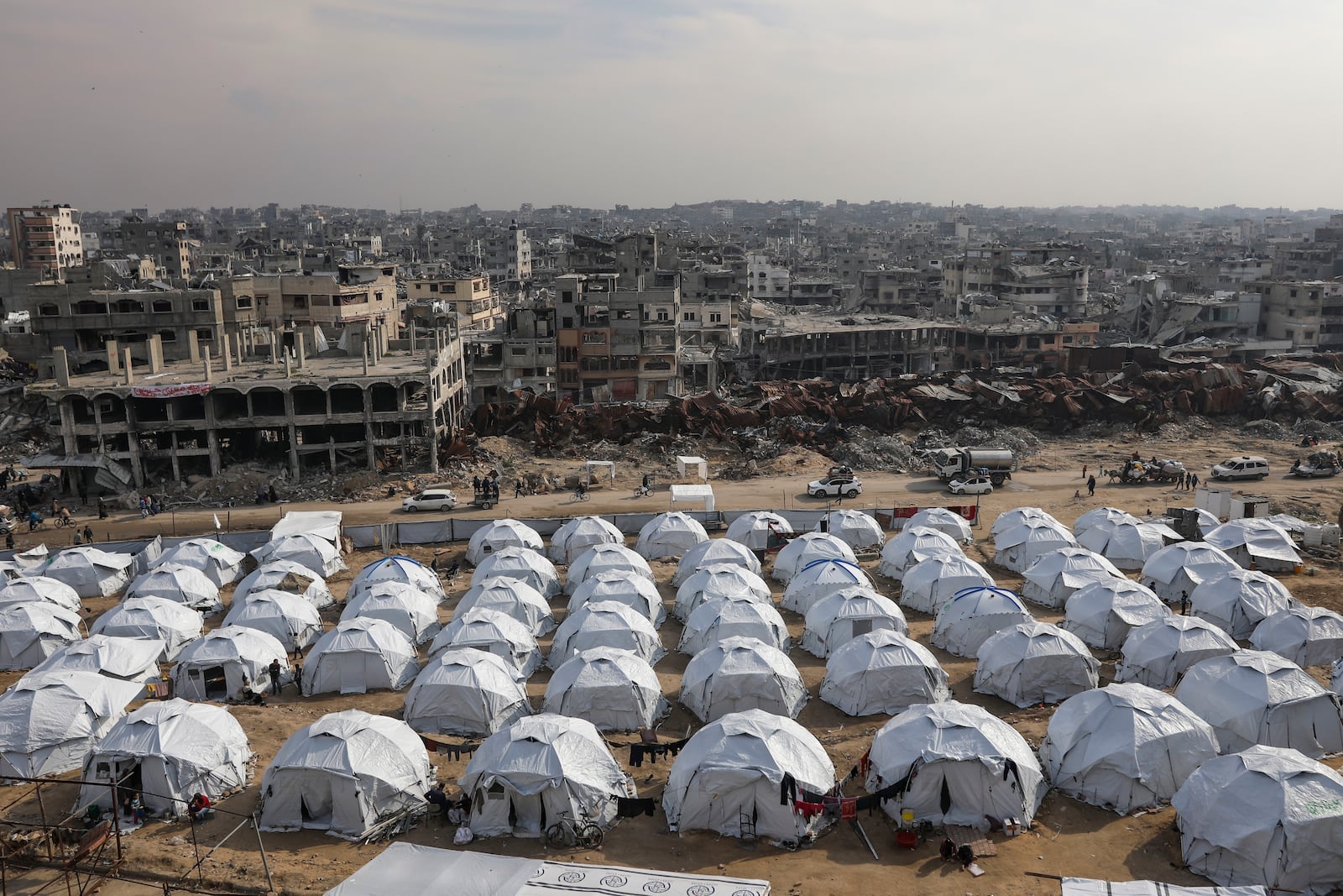 A tent camp for displaced Palestinians is set up amid destroyed buildings in Shijaiyah neighbourhood, Gaza City, Tuesday, Jan. 28, 2025. (AP Photo/Jehad Alshrafi)