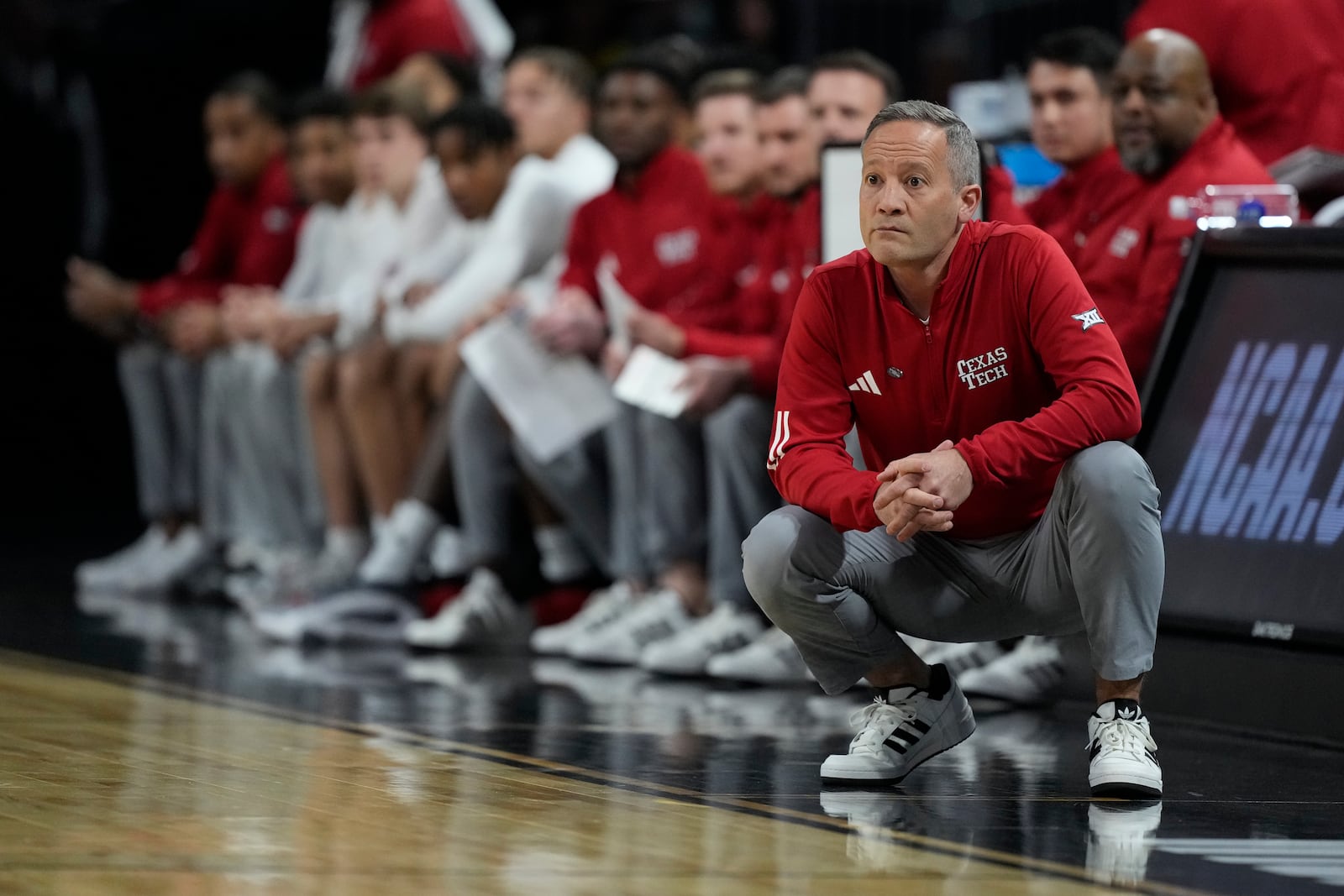 Texas Tech head coach Grant McCasland watches during the first half of a game against UNC Wilmington in the first round of the NCAA college basketball tournament, Thursday, March 20, 2025, in Wichita, Kan. (AP Photo/Charlie Riedel)