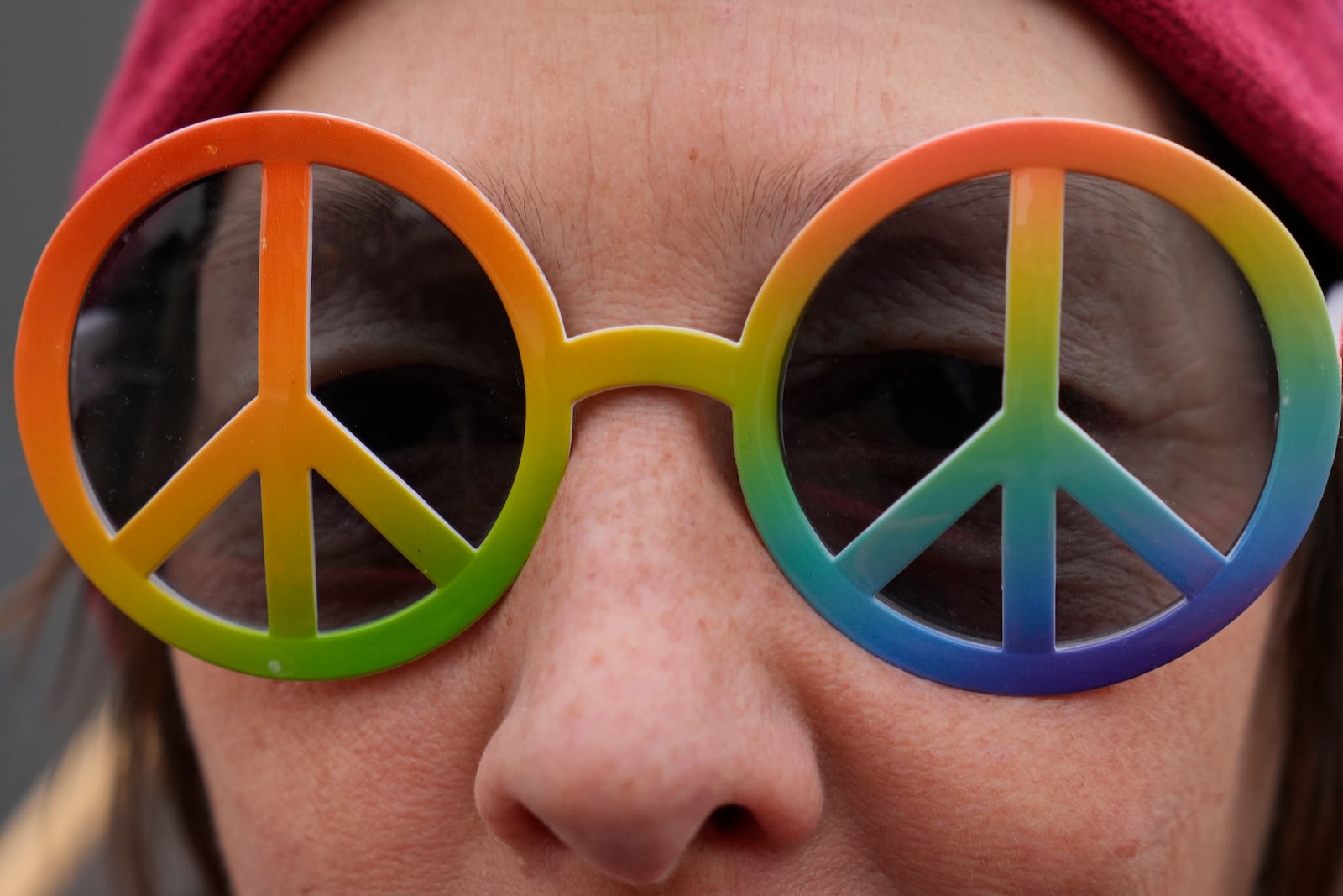 A woman attends a demonstration against the Munich Security Conference in Munich, Saturday, Feb. 15, 2025. Slogan in front of reads : .No war in my name' and in the background: 'For Peace and disarmament'.(AP Photo/Ebrahim Noroozi)