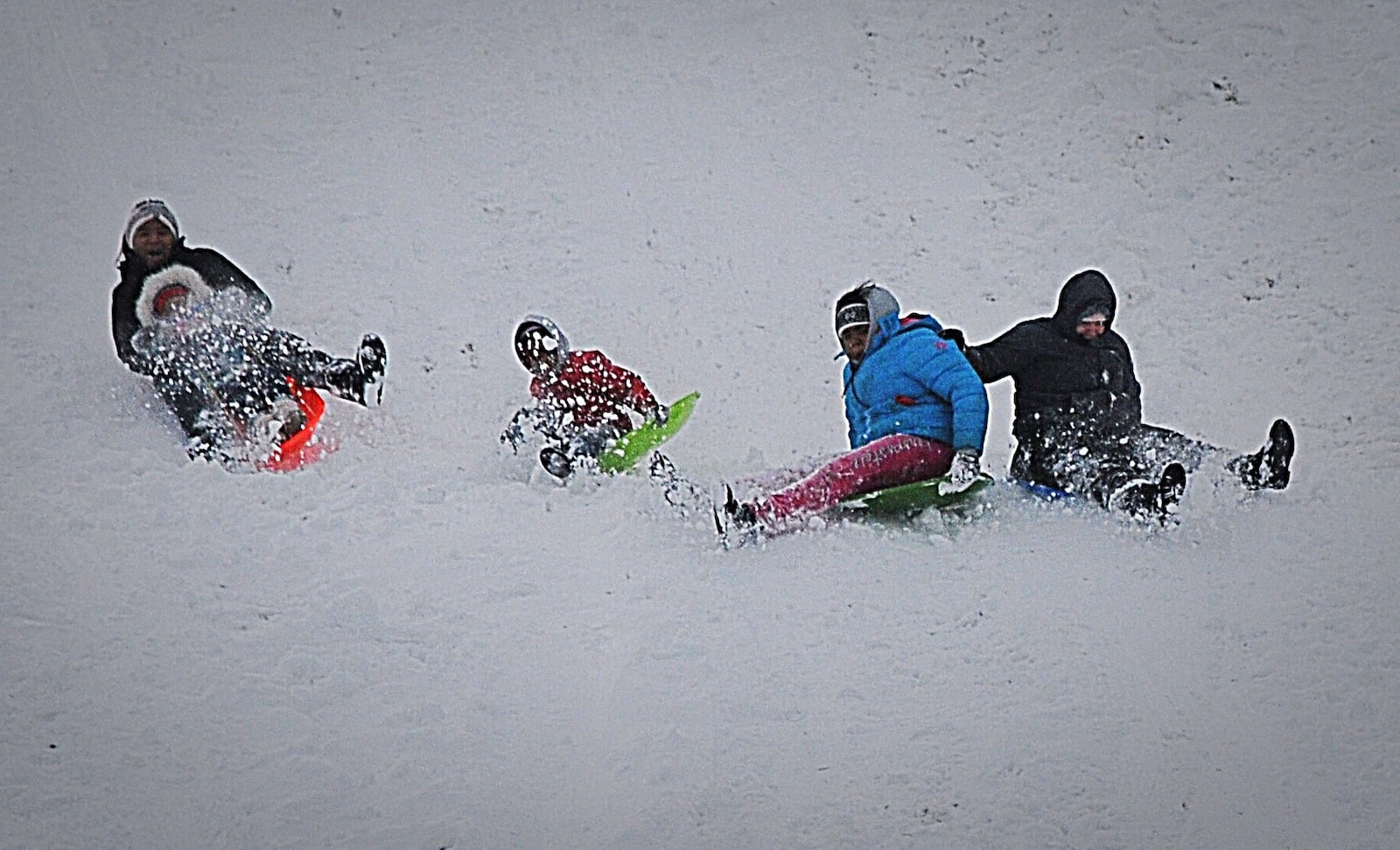 Many kids, including this group in Springfield, took advantage of the snowfall over the weekend and went sledding. STAFF PHOTO / MARSHALL GORBY