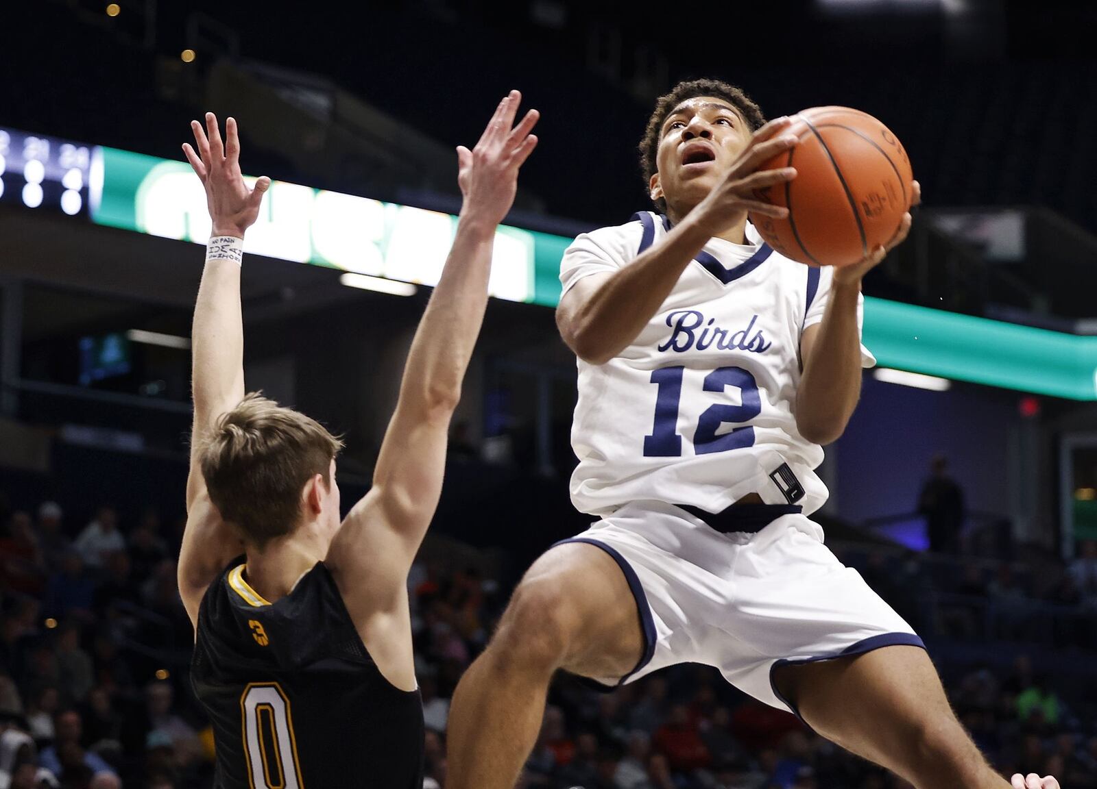 Kettering Fairmont's Anthony Johnson goes to the hoop defended by Centerville's Gabe Cupps during their Division I regional basketball game Wednesday, March 9, 2022 at Cintas Center on the Xavier University campus in Cincinnati. Centerville won 44-42. NICK GRAHAM/STAFF