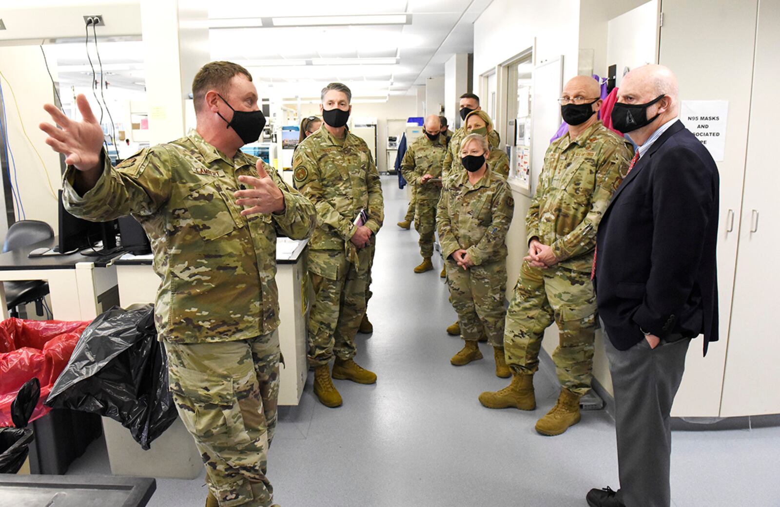 Acting Secretary of the Air Force John Roth, right, and Gen. Arnold W. Bunch Jr., commander, Air Force Materiel Command, listen to a presentation about the U.S. Air Force School of Aerospace Medicine Epidemiology Laboratory at Wright-Patterson Air Force Base, Ohio, March 23, 2021.  The lab is responsible for analyzing a majority of the COVID-19 tests in the Air Force. Roth met with Air Force personnel and toured several facilities at the base including the National Air and Space Intelligence Center. U.S. AIR FORCE PHOTO/TY GREENLEES