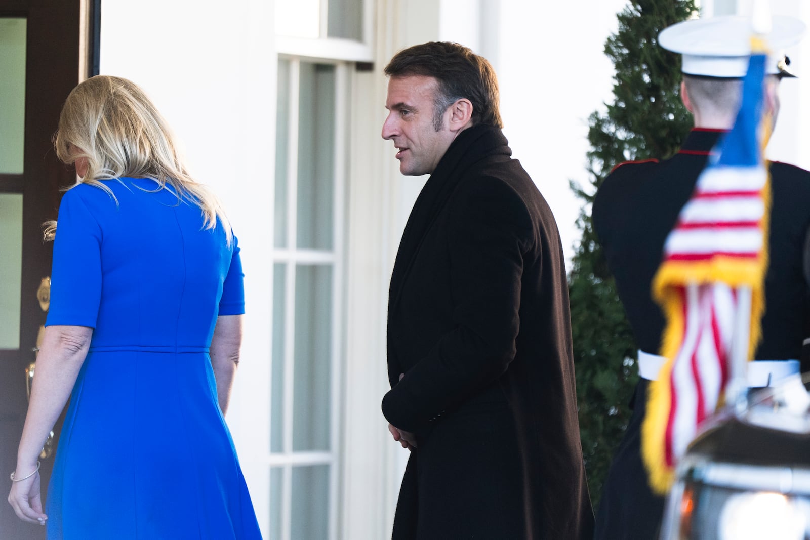 French President Emmanuel Macron is escorted by Chief of Protocol Monica Crowley as he arrives at the White House, Monday, Feb. 24, 2025, in Washington. (AP Photo/Manuel Balce Ceneta)