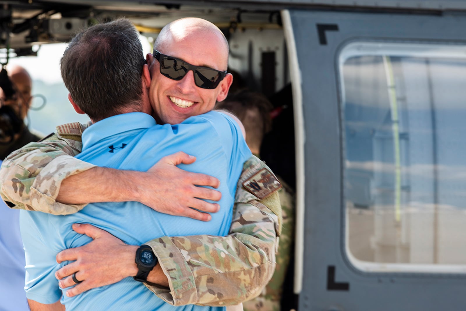 Tech. Sgt. Michael Frank, a special missions aviator with the 512th Rescue Squadron out of Kirtland Air Force Base, New Mexico, is greeted by family members upon his arrival at Wright-Patterson AFB on Sept. 1. Frank serves on an HH-60W Jolly Green II helicopter that made a stopover at Wright-Patt while en route from Moody AFB, Georgia, back to Kirtland AFB. U.S. AIR FORCE PHOTO/WESLEY FARNSWORTH