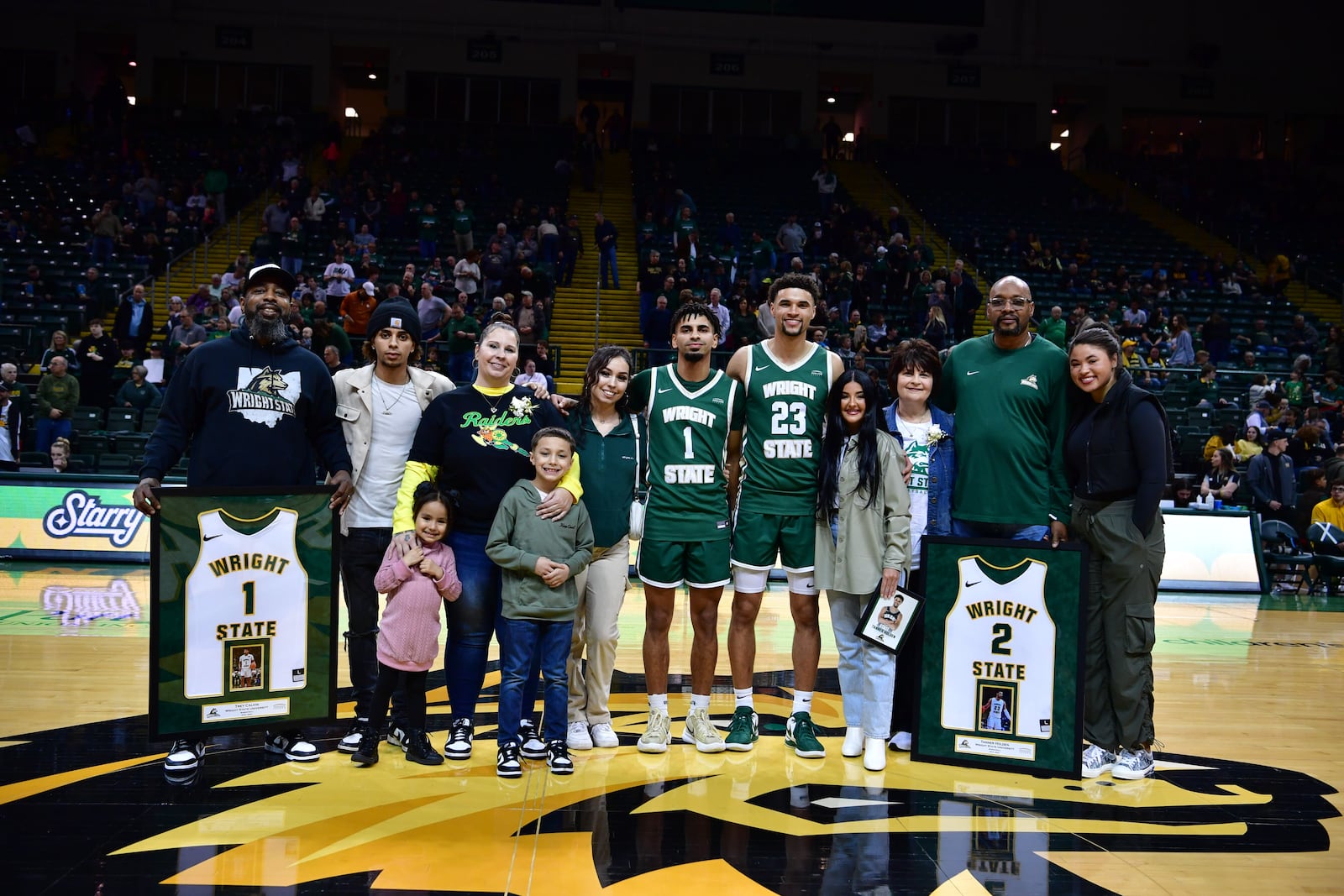 Wright State's Trey Calvin (1) and Tanner Holden pose with their families during pre-game Senior Night festivities Saturday at the Nutter Center. Joe Craven/WSU Athletics