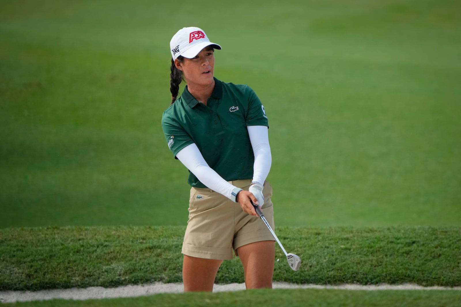 Celine Boutier, of France, hits from a fairway bunker at the 3rd fairway during the first round of Maybank LPGA Championship golf tournament at Kuala Lumpur Golf and Country club in Kuala Lumpur, Thursday, Oct. 24, 2024. (AP Photo/Vincent Thian)