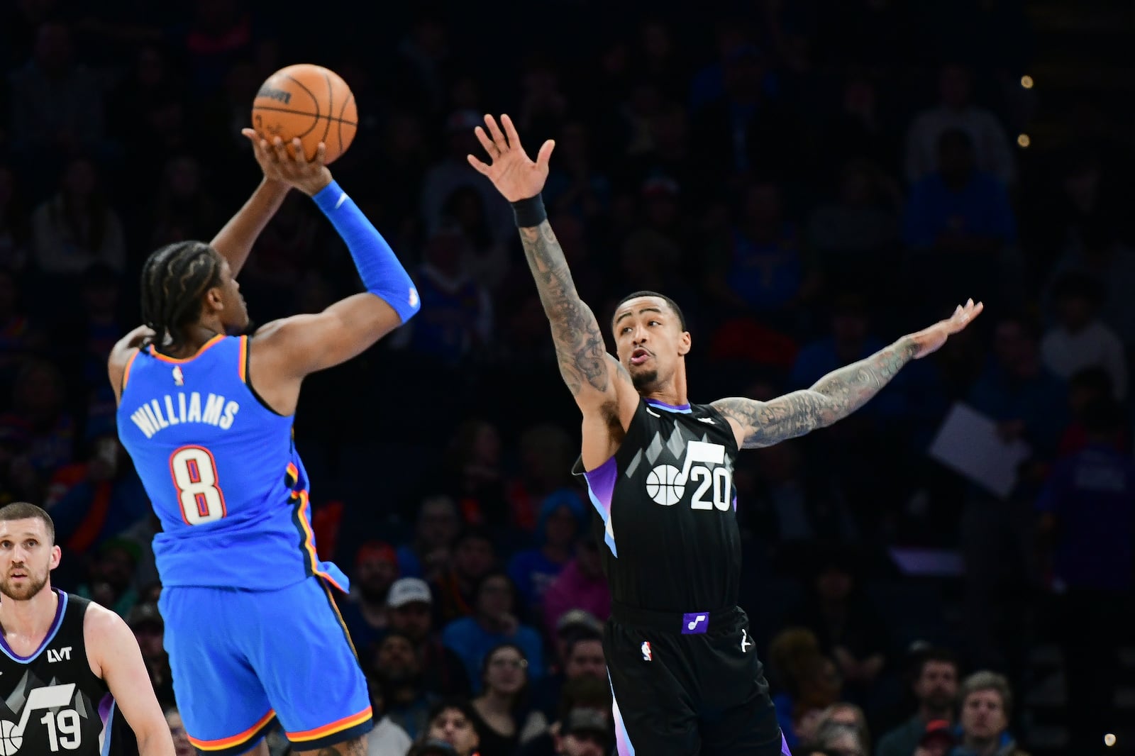 Utah Jazz forward John Collins (20 tries to block a shot by Oklahoma City Thunder forward Jalen Williams (8) during the second half of an NBA basketball game, Wednesday, Jan. 22, 2025, in Oklahoma City. (AP Photo/Kyle Phillips)