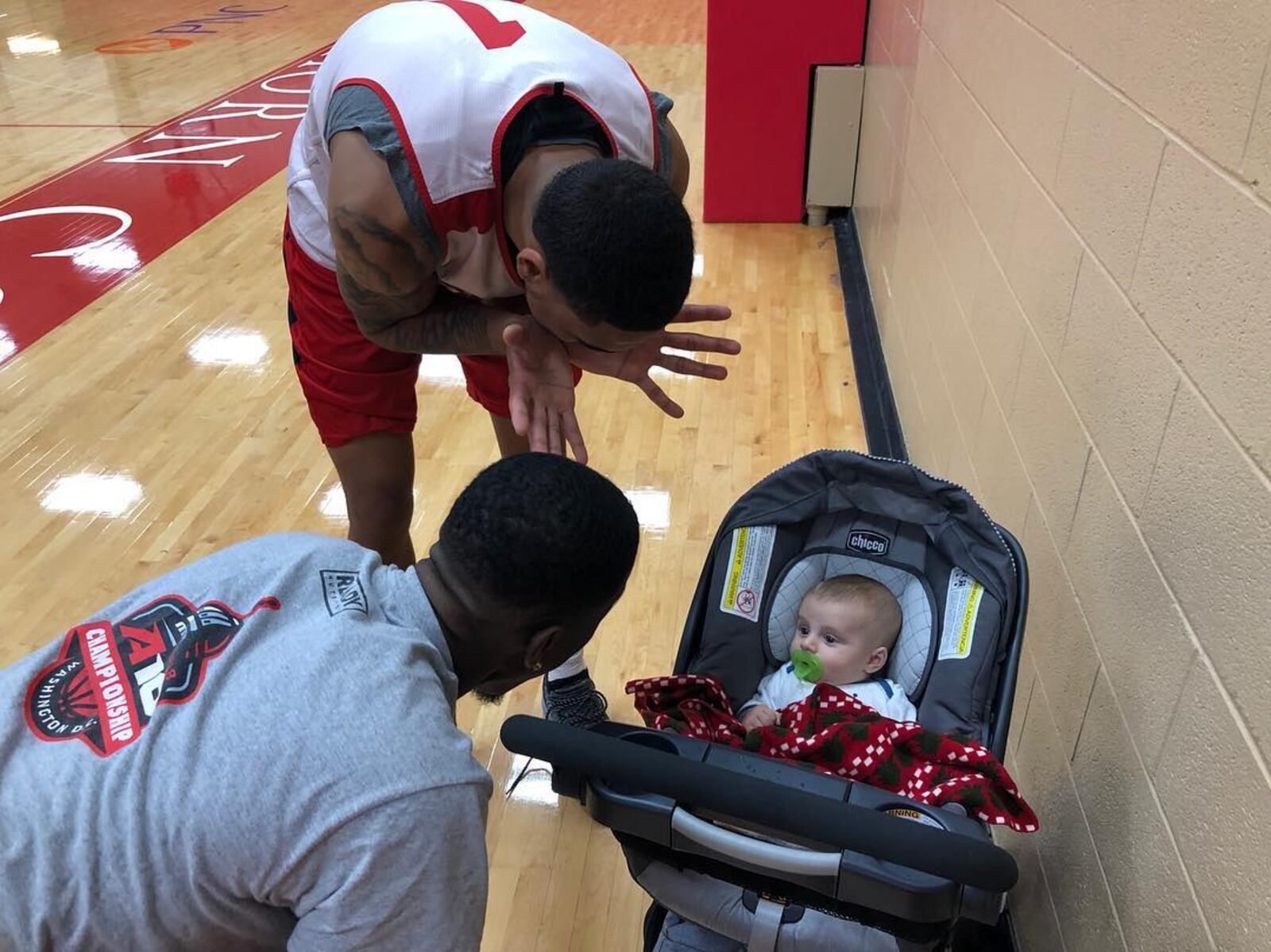 Dayton players Obi Toppin, top, and Jalen Crutcher, left, play Peek A Boo with the author’s son, Chase Jablonski, at an interview session in 2018. Photo by Andy Farrell