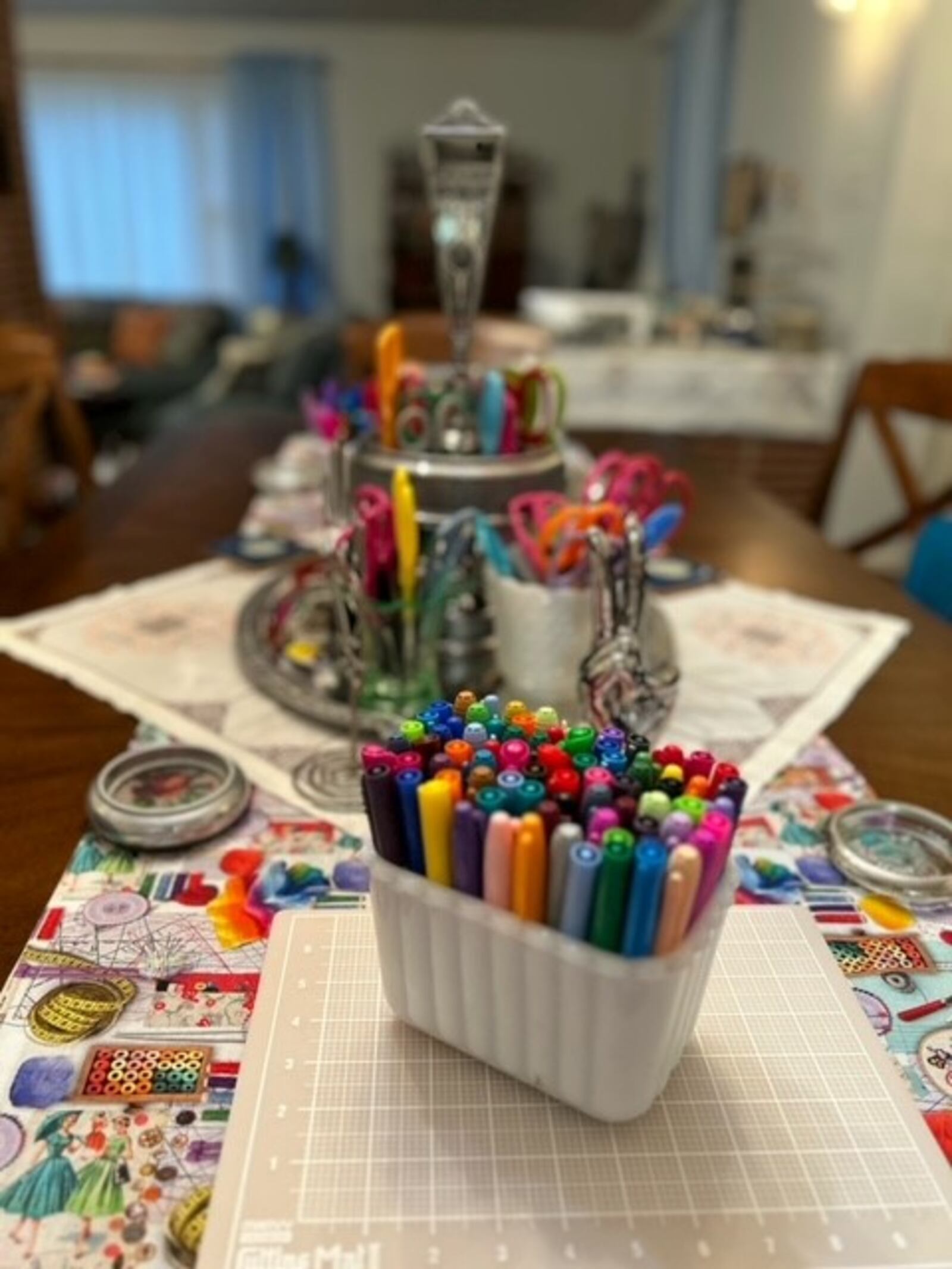 The table is set for crafternoon with all kinds of craft supplies and festive decorations.