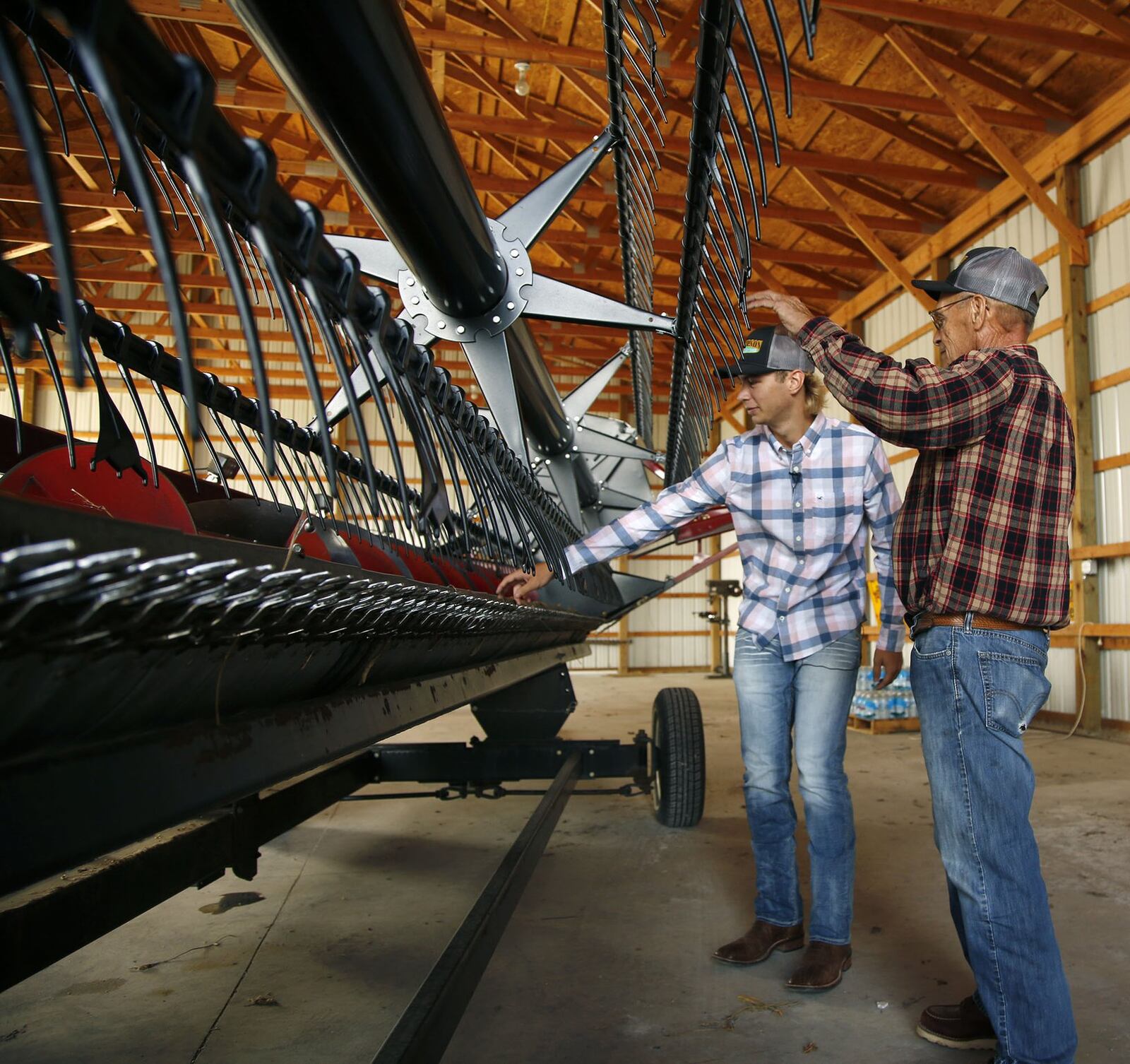 Logan Ressler and his grandfather Dean Thompson are concerned about the low prices of soybeans this year but add that fluctuations are part of the business. TY GREENLEES / STAFF