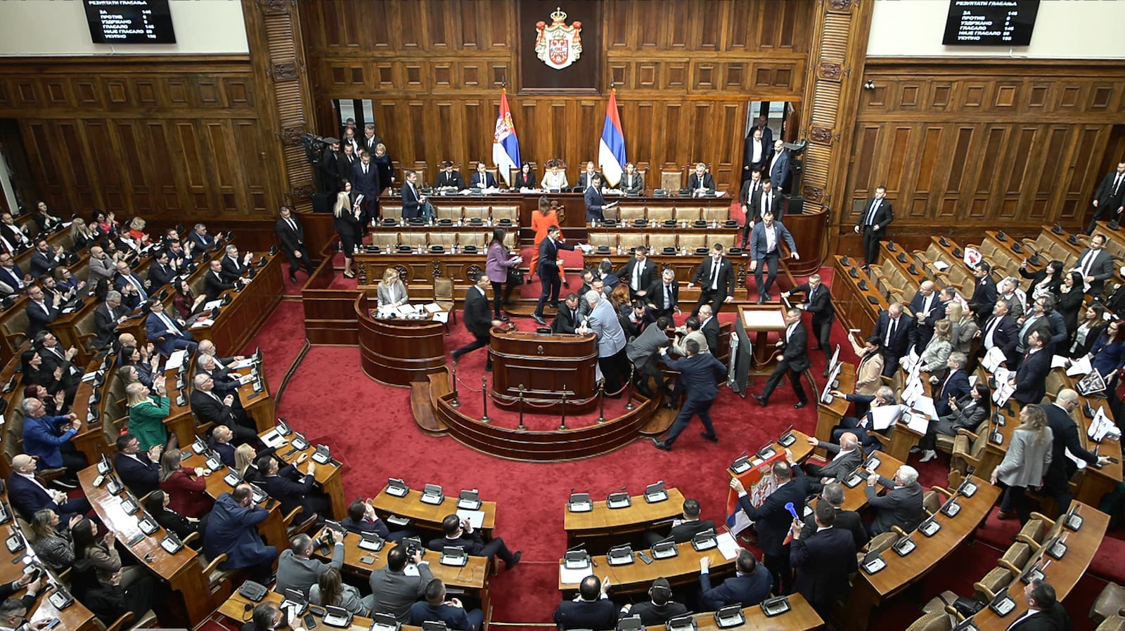 In this grab taken from video provided by RTS Serbia, lawmakers scuffle in parliament, in Belgrade, Serbia, Tuesday, March 4, 2025. (RTS Serbia via AP)