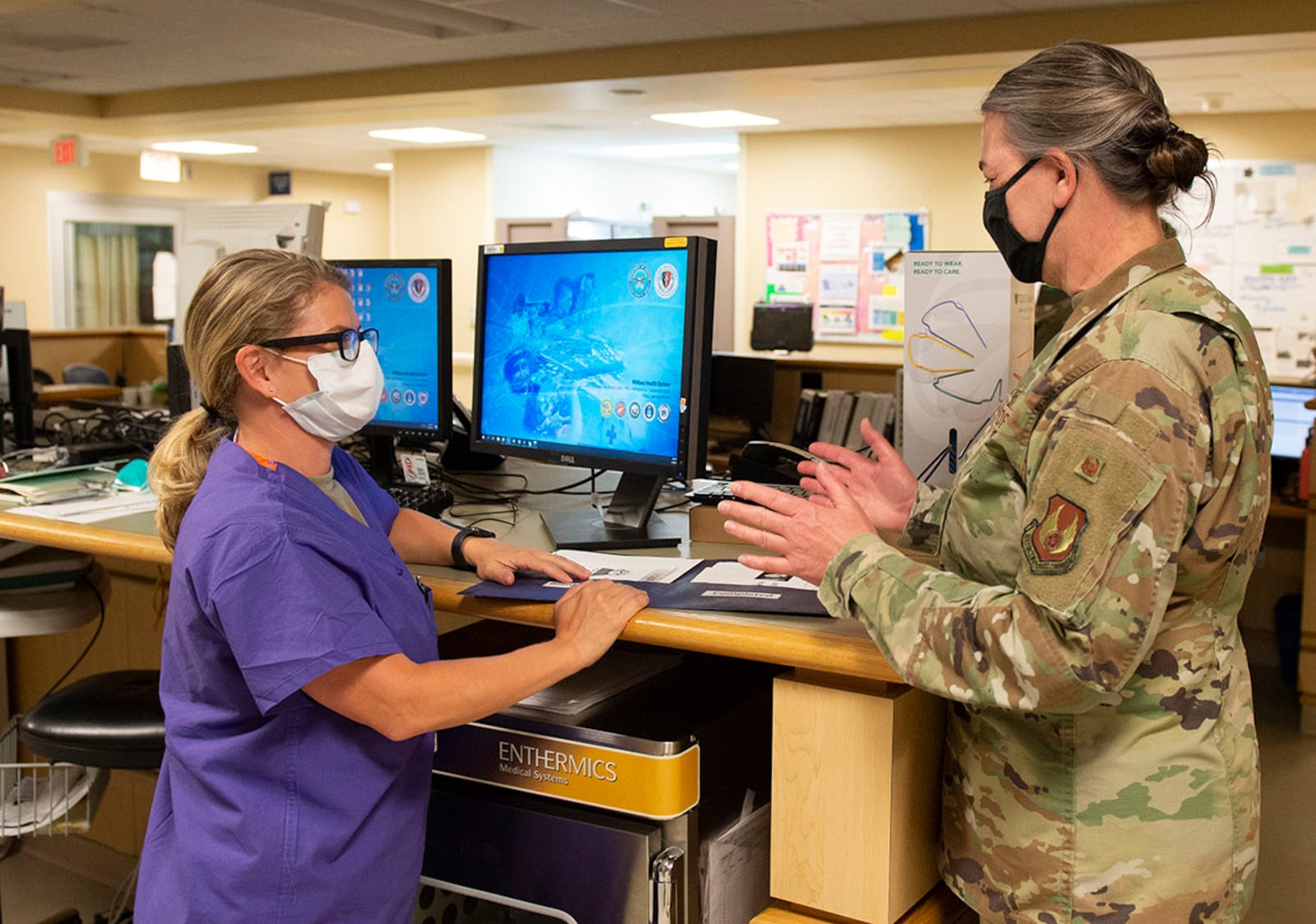 Col. Rachelle Hartze, 88th Medical Group master clinician and evening shift in-house supervisor, talks with Capt. Angela Leonardo, a registered nurse with the 88th Medical Group, inside the emergency room of the Wright-Patterson Medical Center April 28. U.S. AIR FORCE PHOTO/WESLEY FARNSWORTH