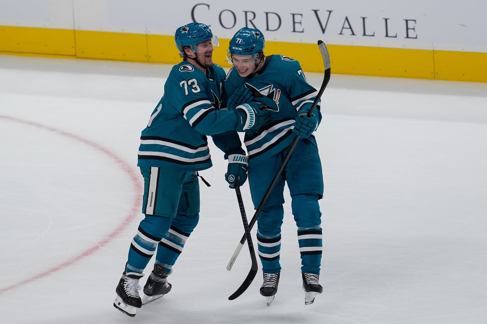 San Jose Sharks' Tyler Toffoli, left, celebrates with Macklin Celebrini, right, after scoring during the first period of an NHL hockey game against the St. Louis Blues, Thursday, Oct. 10, 2024, in San Jose, Calif. (AP Photo/Godofredo A. Vásquez)