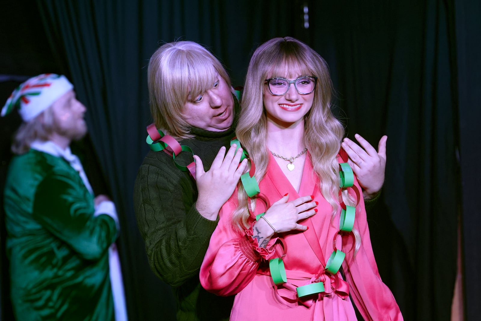 Mickey Howell, center, and GinaKay Howell appear during a dress rehearsal for the production of "The Holiday Channel Christmas Movie Wonderthon" at the Ghostlight Theatre in Sun City West, Ariz., on Dec. 9, 2024. (AP Photo/Ross D. Franklin)