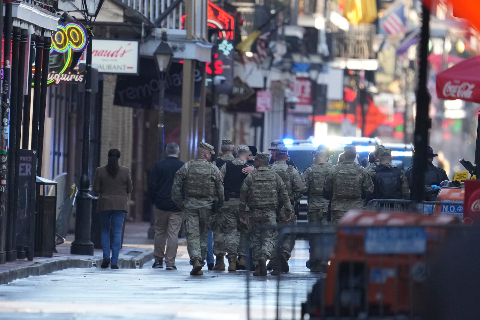 Military personnel walk down Bourbon street, Thursday, Jan. 2, 2025 in New Orleans. (AP Photo/George Walker IV)