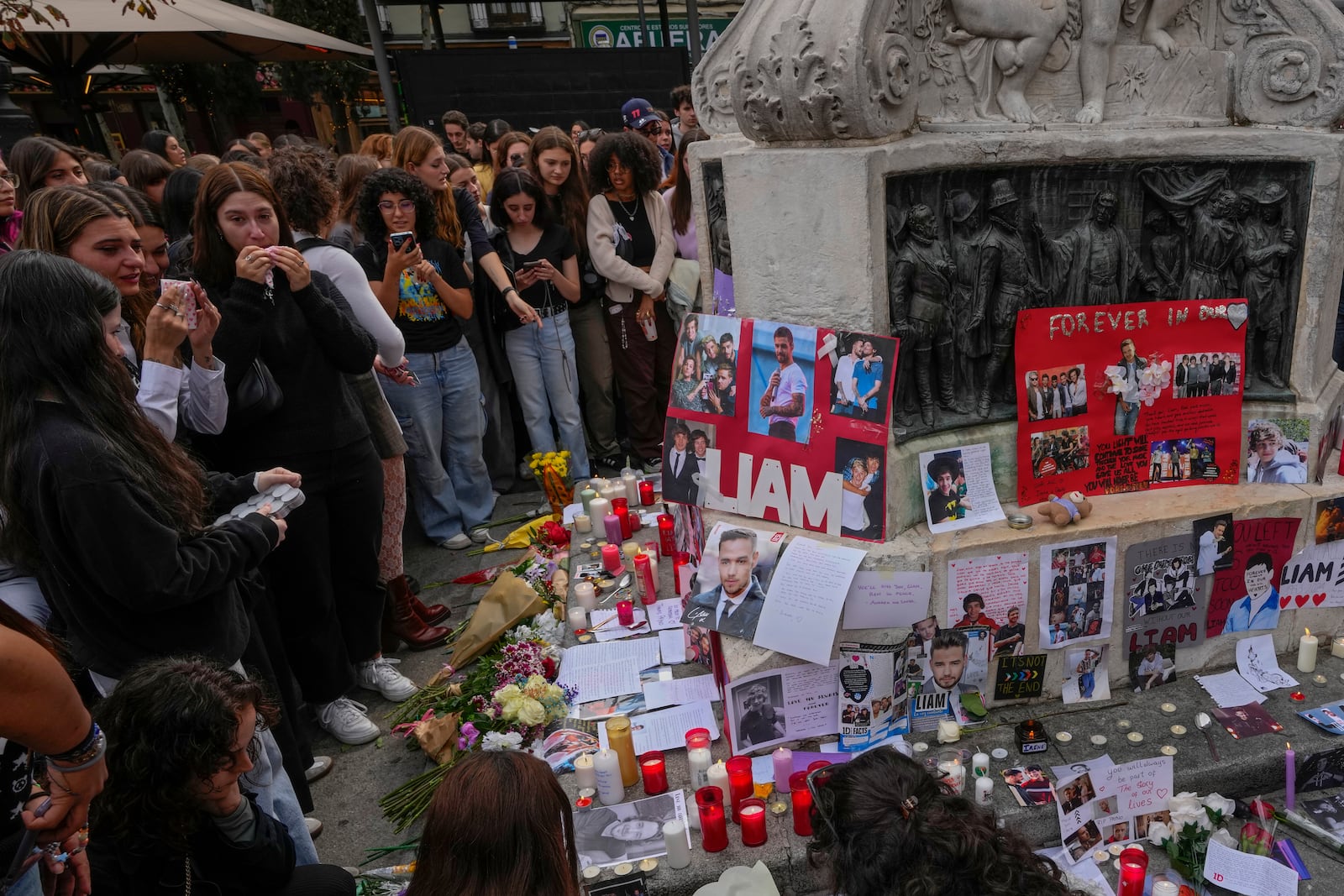 Fans of former One Direction singer Liam Payne gather to honor him in Madrid, Spain, Sunday, Oct. 20, 2024 after the British pop singer fell to his death from a hotel balcony in Buenos Aires, Argentina. (AP Photo/Paul White)