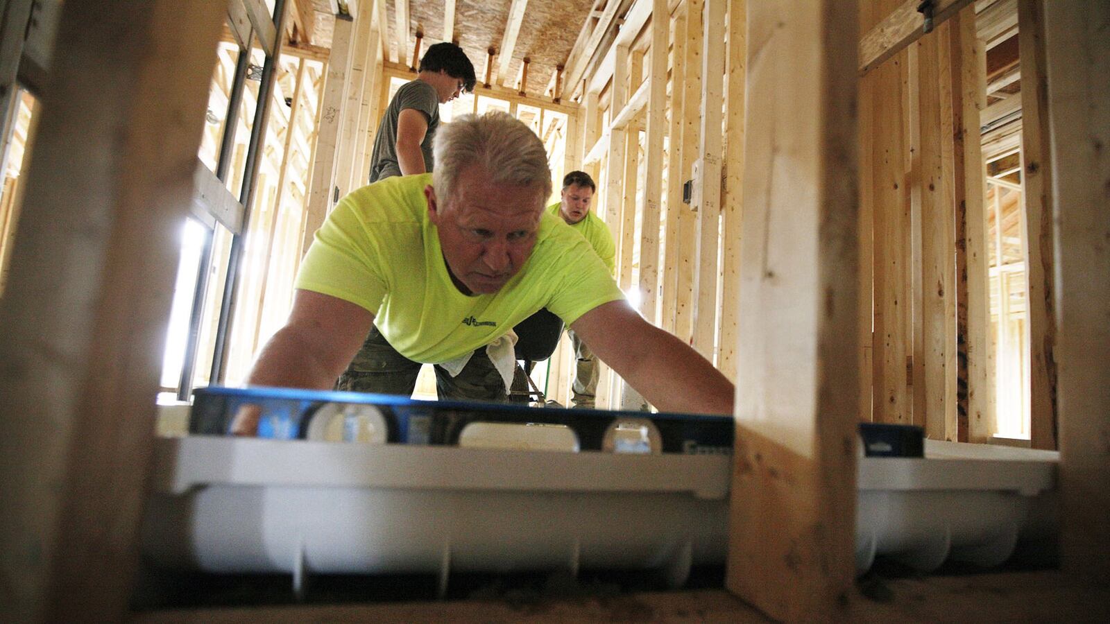 Workers are building ranch-style patio homes at Cottages of Beavercreek, a Charles Simms Development project. Twenty of 80 planned homes have been built and they are priced at $250,000 to $325,000. TY GREENLEES / STAFF