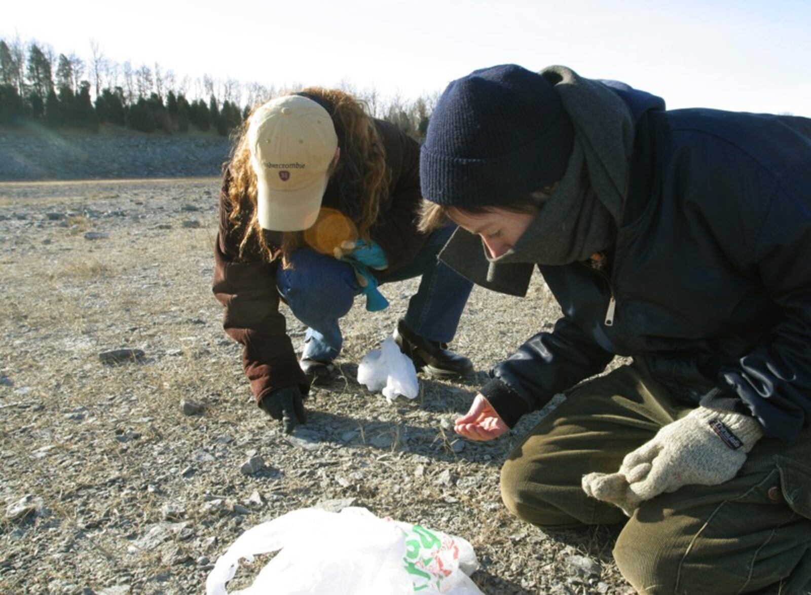 Sisters Rebecca, left, and Sarah Ciampa search through the spillway area of Caesar Creek Lake, where they hunted for fossils on a cold holiday break afternoon in 2012.