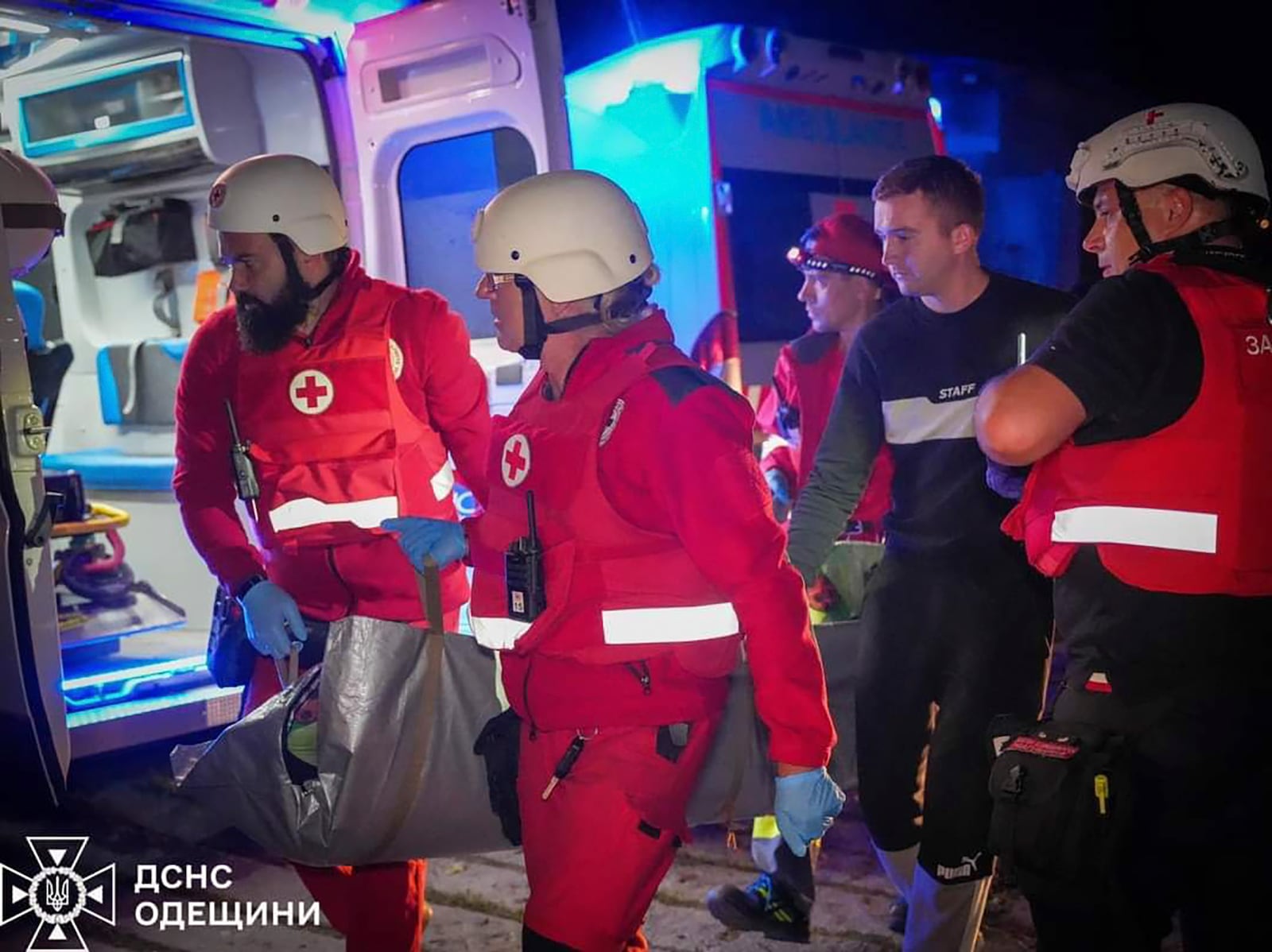 In this photo provided by the Ukrainian Emergency Service, Emergency workers carry a wounded resident after Russian missile attack in Odesa, Ukraine, late Thursday, Oct. 10, 2024. Four Russian missile and drone attacks on the Odesa region this week have killed 14 people and wounded around 20, according to local officials. (Ukrainian Emergency Service via AP)