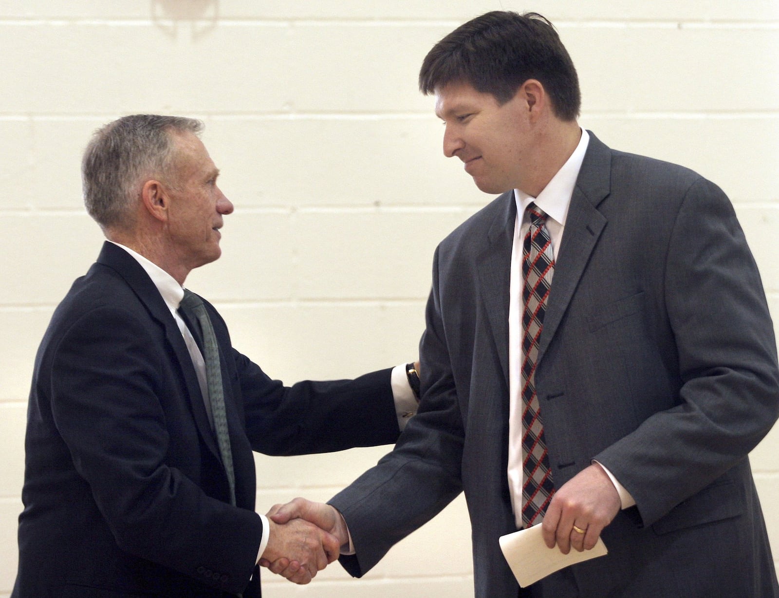 WSU men’s head basketball coach, Brad Brownell was introduced to the local Dayton media in 2006. He shakes athletic director, Mike Cusack’s hand after his address to the media and interested Raider fans. DDN FILE