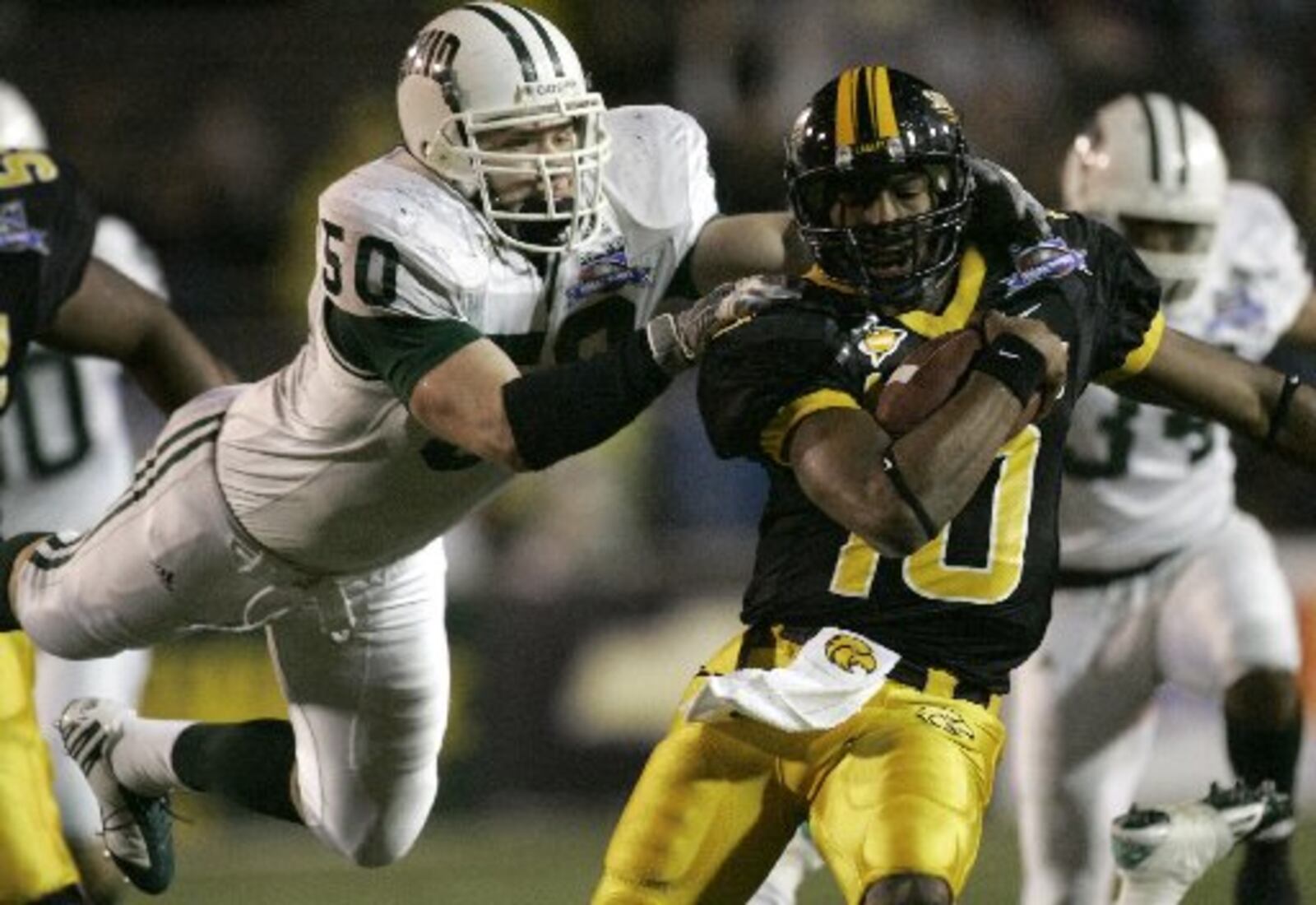 Ohio University's Matt Muncy (50) tackles Southern Mississippi's Jeremy Young (10) during the first quarter of the GMAC Bowl football game, Sunday Jan. 7, 2007, in Mobile, Ala. (AP Photo/Rob Carr)