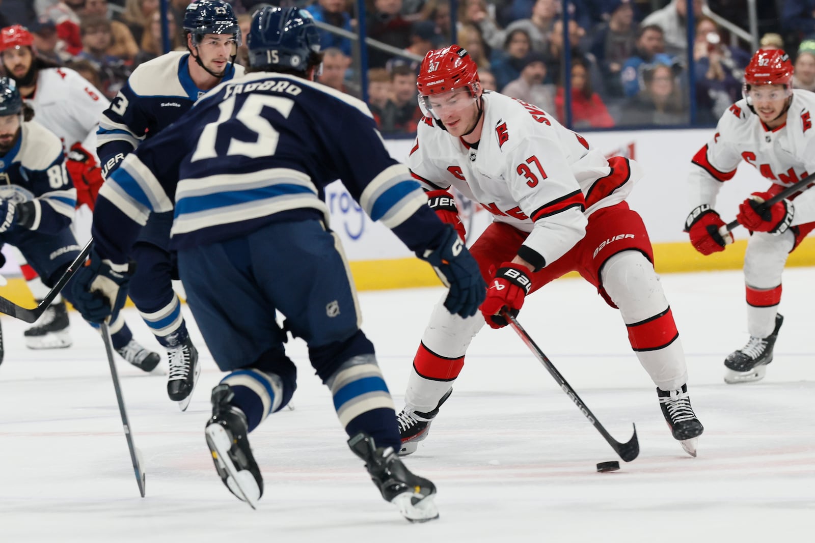 Carolina Hurricanes' Andrei Svechnikov, right, carries the puck across center ice as Columbus Blue Jackets' Dante Fabbro defends during the first period of an NHL hockey game Tuesday, Dec. 31, 2024, in Columbus, Ohio. (AP Photo/Jay LaPrete)