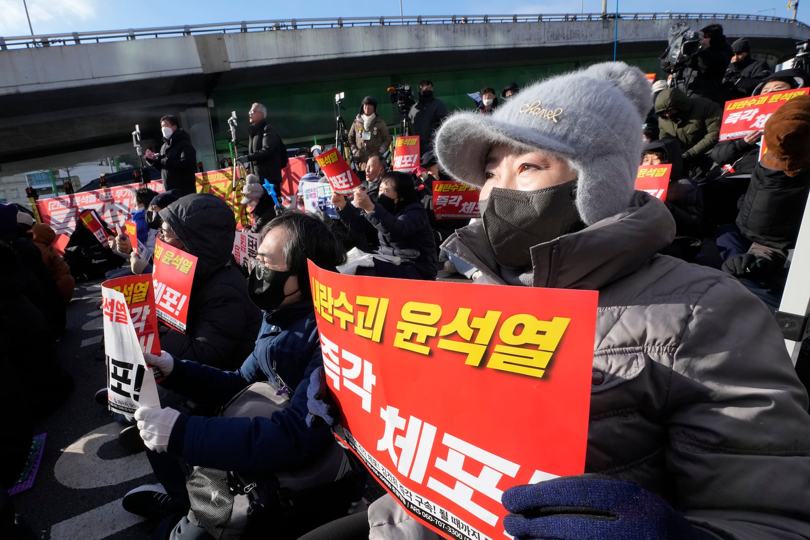 Protesters attend a rally demanding the arrest of impeached South Korean President Yoon Suk Yeol near the presidential residence in Seoul, South Korea, Thursday, Jan. 9, 2025. The letters read "Arrest Yoon Suk Yeol." (AP Photo/Ahn Young-joon)