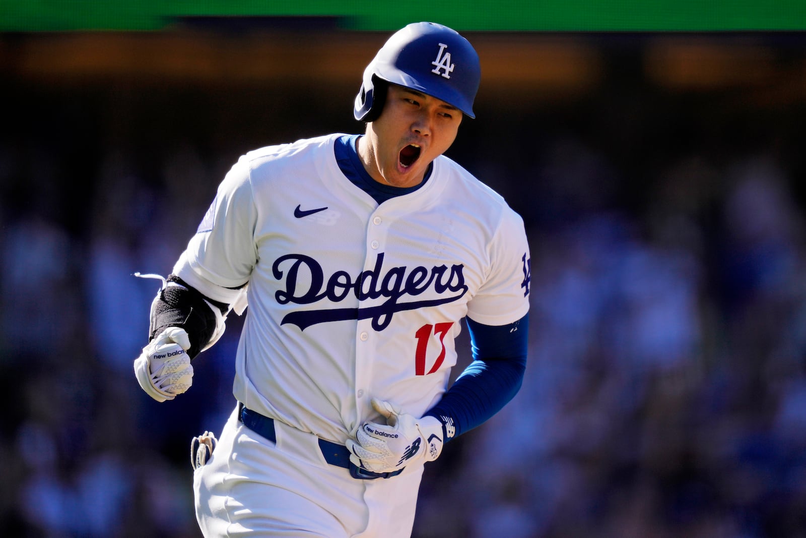 FILE - Los Angeles Dodgers' Shohei Ohtani celebrates as he heads to first for a solo home run during the ninth inning of a baseball game against the Colorado Rockies, Sunday, Sept. 22, 2024, in Los Angeles. (AP Photo/Mark J. Terrill, File)