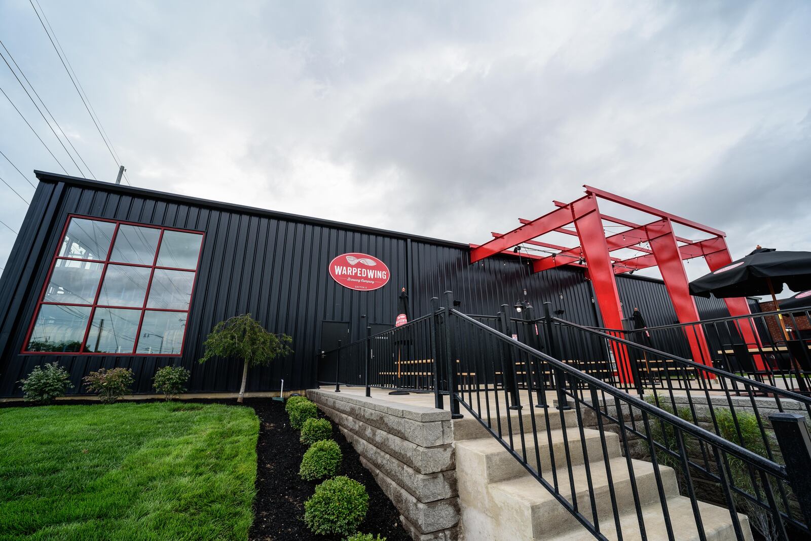 The patio at Warped Wing Barrel Room & Smokery in Springboro. TOM GILLIAM/CONTRIBUTING PHOTOGRAPHER