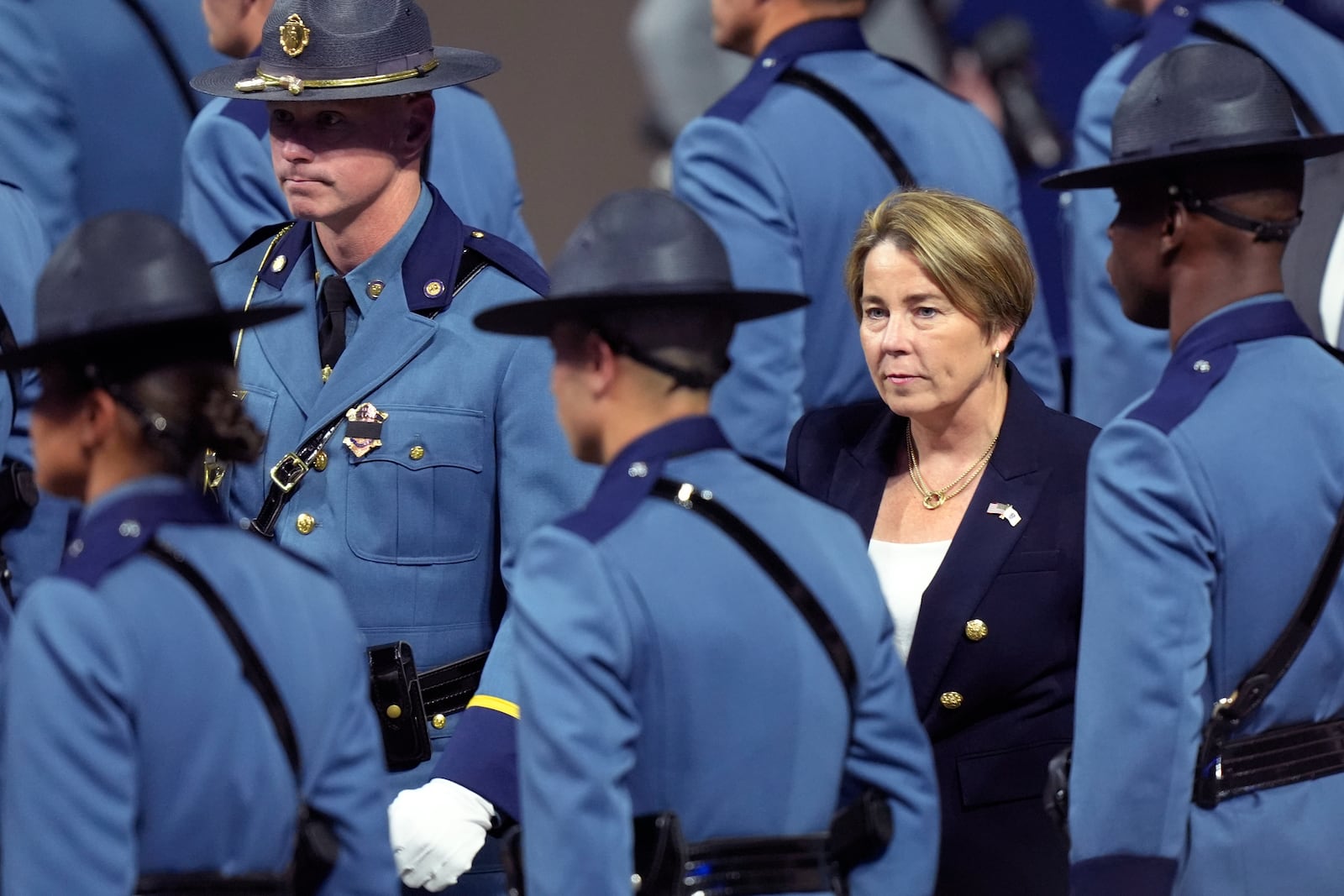 FILE - Massachusetts Gov. Maura Healey, right, walks among members of the 90th Recruit Training Group of the Massachusetts State Police, during a swearing in ceremony in Worcester, Mass., Oct. 9, 2024. (AP Photo/Steven Senne, File)