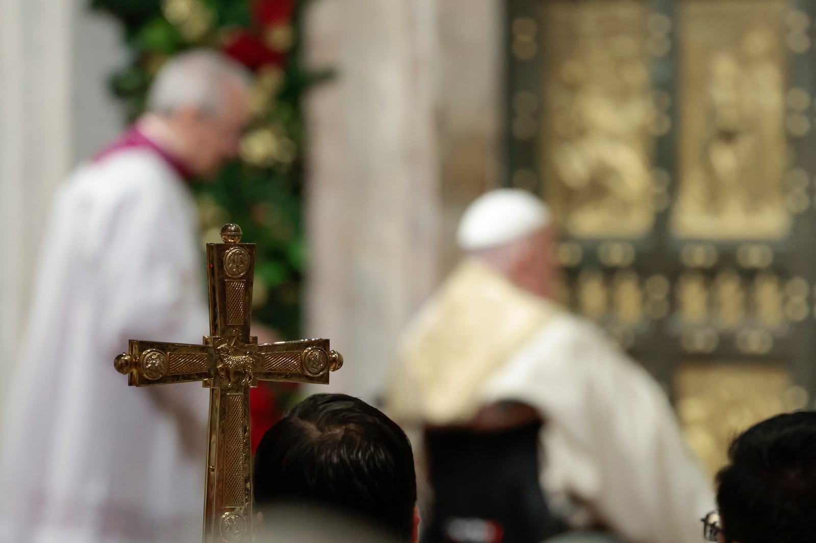 Pope Francis opens the Holy Door to mark the opening of the 2025 Catholic Holy Year, or Jubilee, in St. Peter's Basilica, at the Vatican, Tuesday Dec. 24, 2024. (Remo Casilli/Pool via AP)