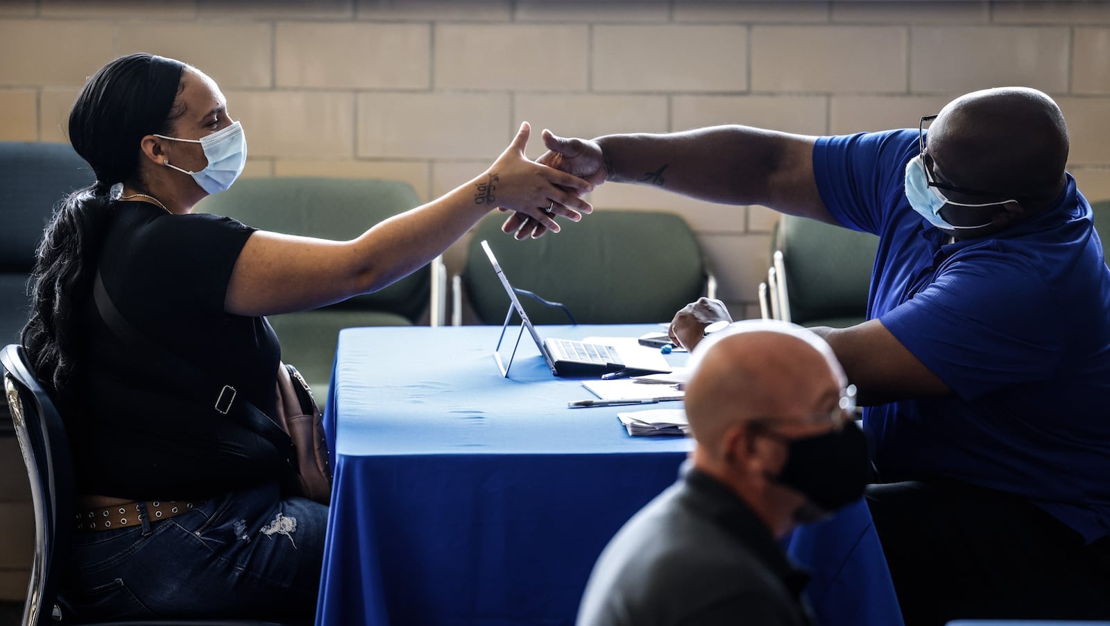 Mary Johnson shakes the hand of Dayton Public Schools human resources partner, Andrae Hicks Wednesday Sept. 29, 2021 after a job interview. Dayton Public Schools held a job fair at Jackson Center on Abbey Ave. JIM NOELKER/STAFF