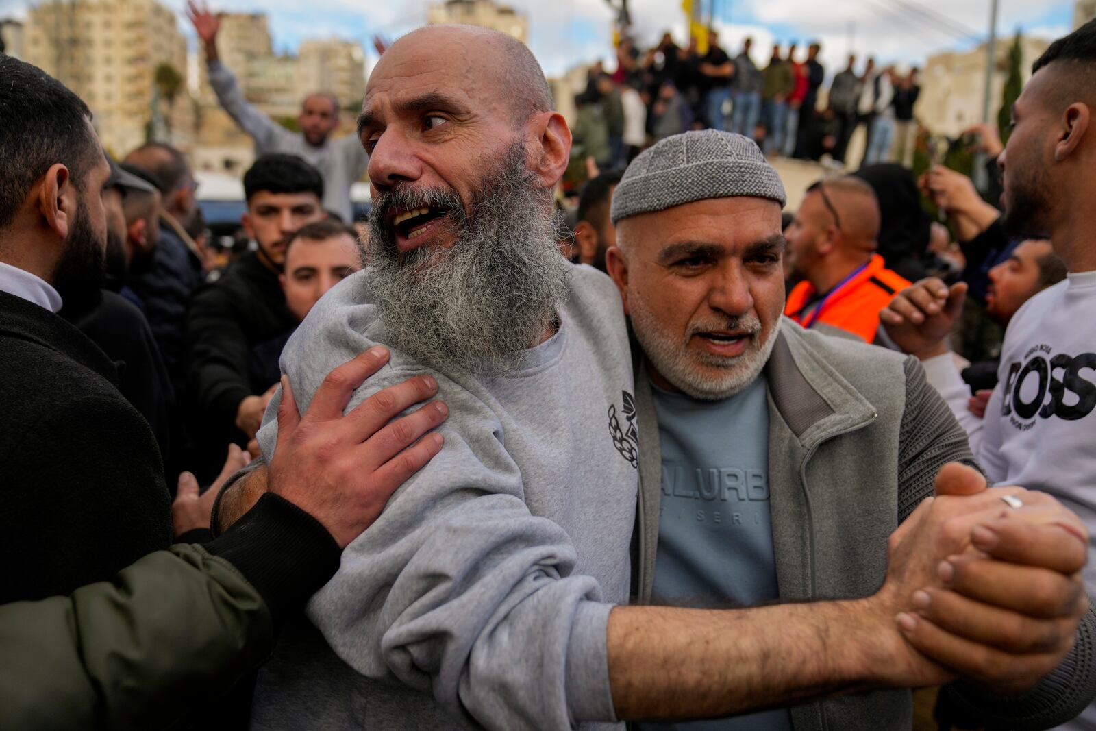 Palestinian prisoners are greeted by a crowd after being released from Israeli prison following a ceasefire agreement with Israel, in the West Bank city of Ramallah, Saturday, Jan. 25, 2025. (AP Photo/Nasser Nasser)