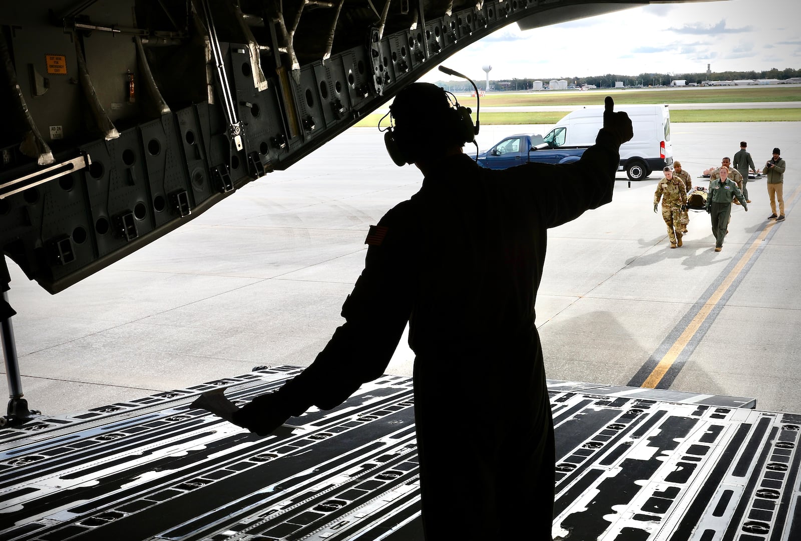 A C-17 Globemaster III crew load medical manikins during a mock evacuation drill Wednesday, October 16, 2024 at Wright Patterson Air Force Base. MARSHALL GORBY \STAFF