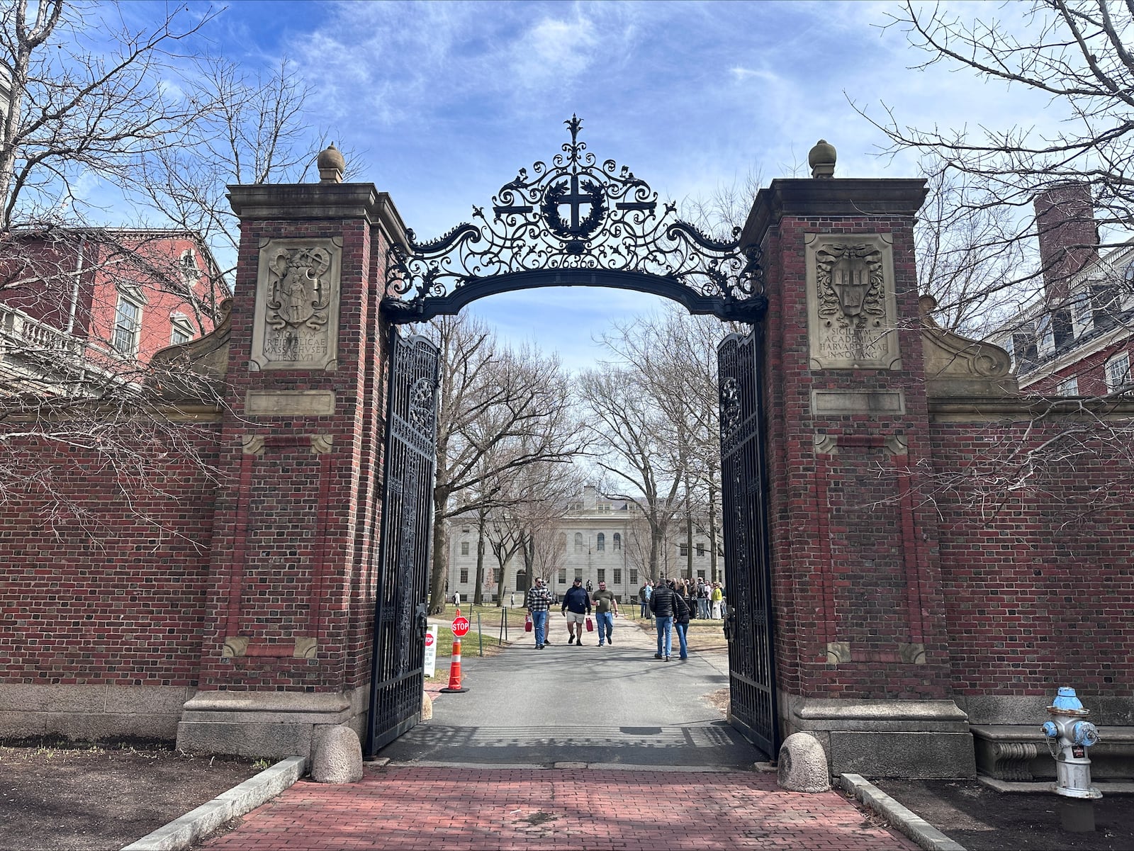 People walk through the campus of Harvard University in Cambridge, Mass., Tuesday, March 18, 2025, which announced plans to make tuition free for students of families making up to $200,00. (AP Photos/Michael Casey)