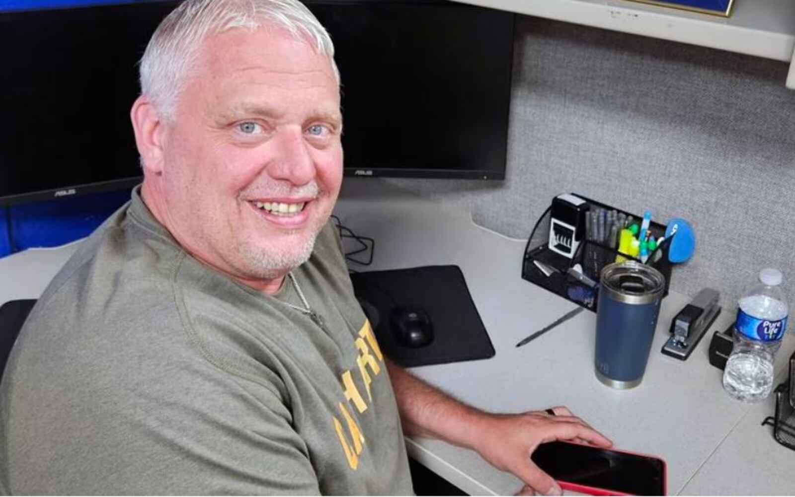 Michael Wise at his desk at Five Star Services where he was hired in 2020 to be a warehouse manager despite having multiple felony convictions and no high school diploma or GED. He is in recovery after spending decades addicted to drugs. The photos on his desk are of wife Amanda and their son Preston, now 20 months old. CONTRIBUTED