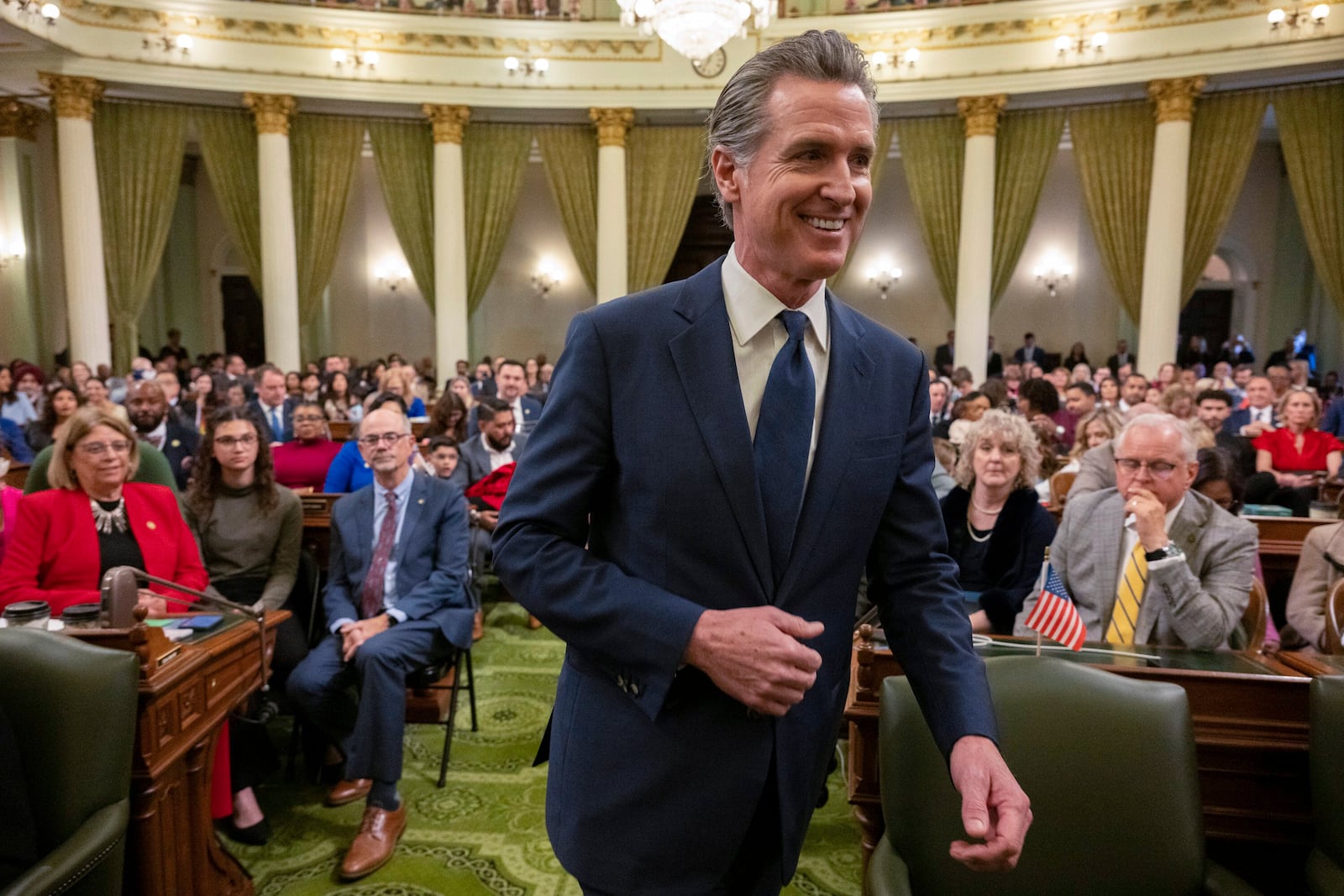 Gov. Gavin Newsom walks down the aisle at the State Capitol during a meeting of the new legislative session on Monday, Dec. 2, 2024, in Sacramento. (Paul Kitagaki Jr./The Sacramento Bee via AP, Pool)