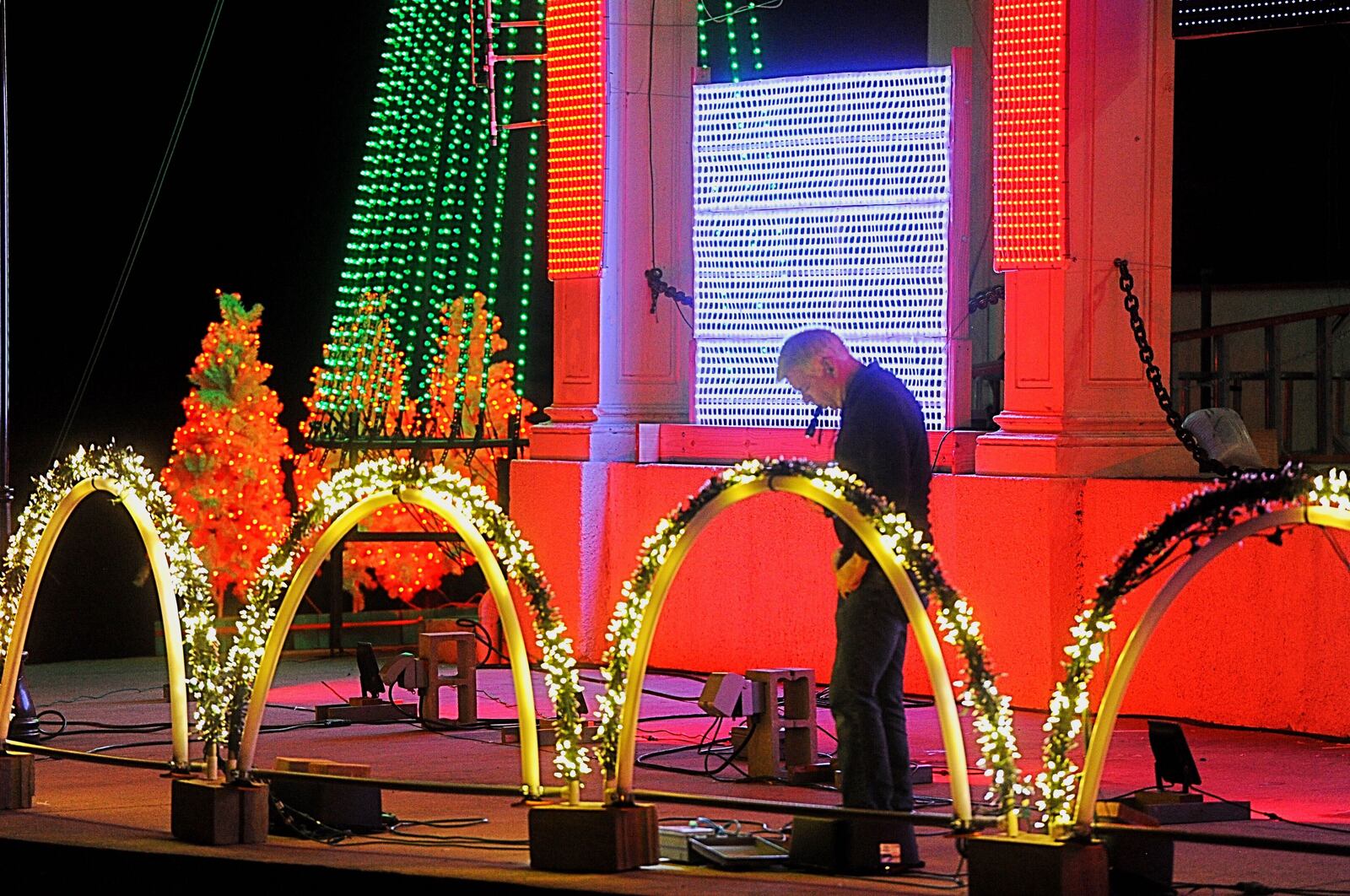 Xenia police chief, Randy Person, works on setting up the Xenia Lights, Monday night, Nov. 9, at Shawnee park.