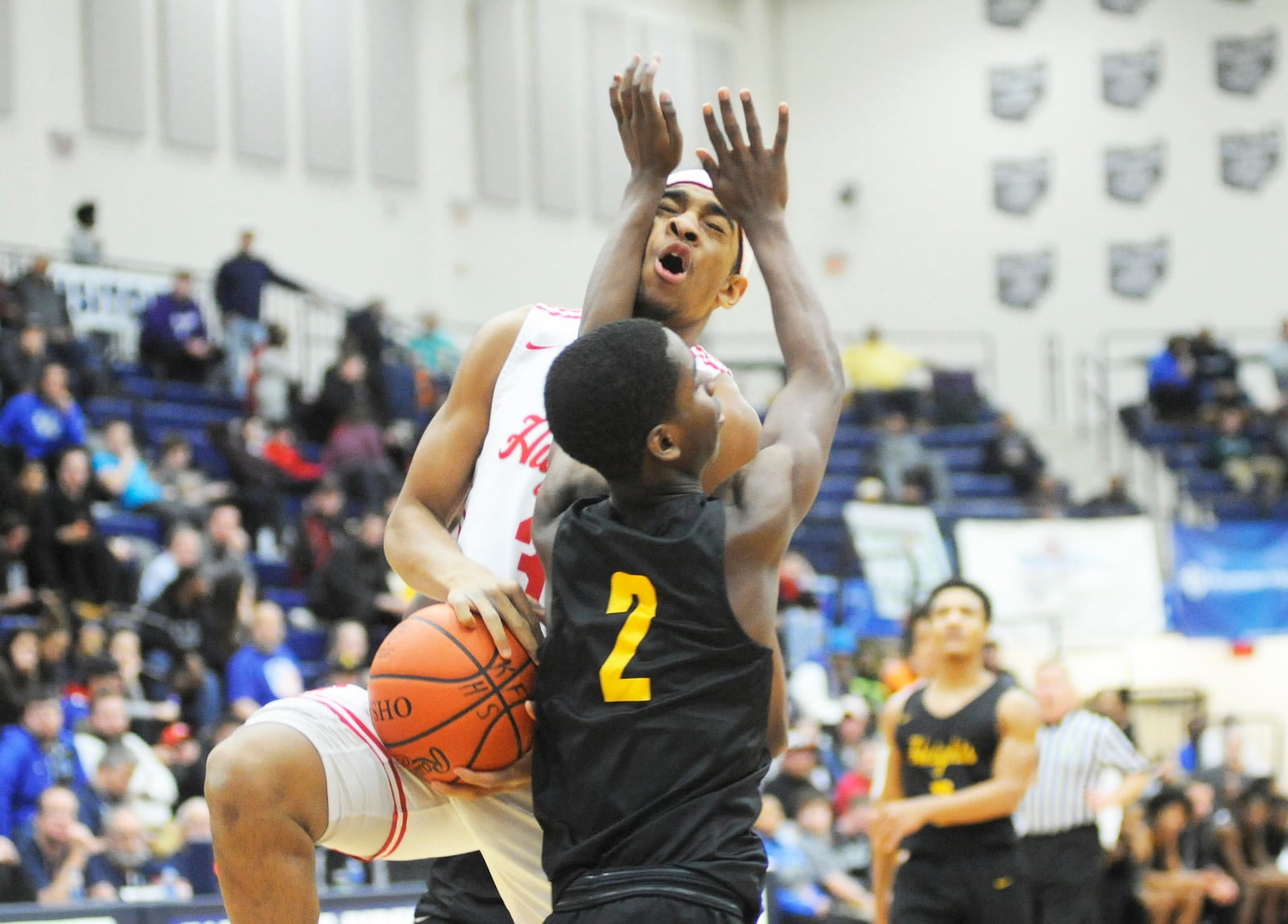 Tyon Thompson of Hughes (with ball) meets a defender. MARC PENDLETON / STAFF