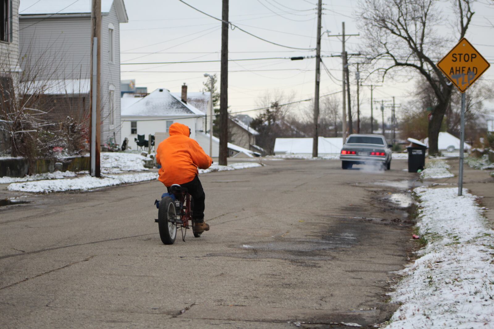 A man rides a motorized bicycle in East Dayton. CORNELIUS FROLIK / STAFF