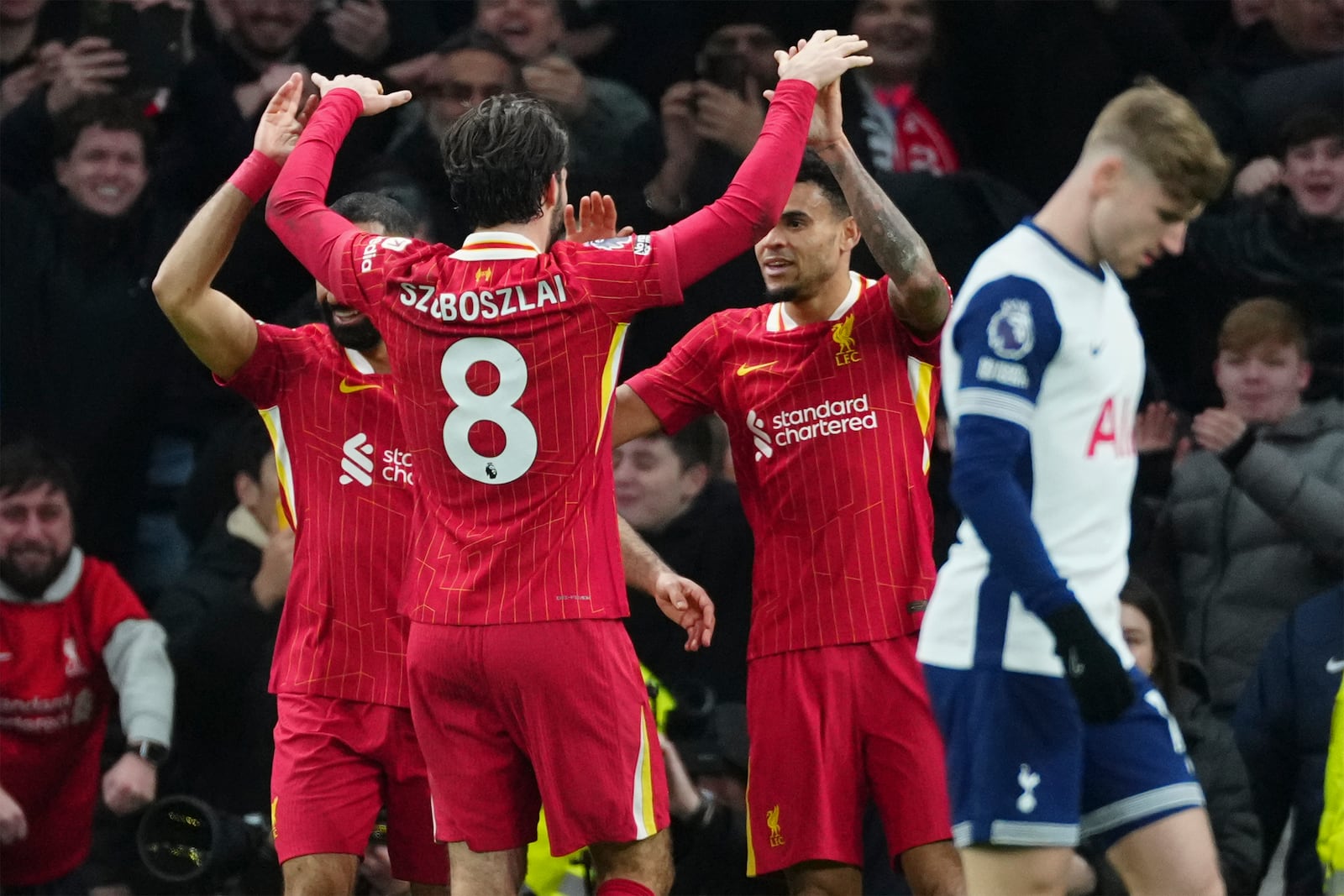 Liverpool's Luis Diaz, second right, celebrates with teammates after scoring his side's sixth goal during the English Premier League soccer match between Tottenham and Liverpool at Tottenham Hotspur Stadium in London, Sunday, Dec. 22, 2024. (AP Photo/Dave Shopland)