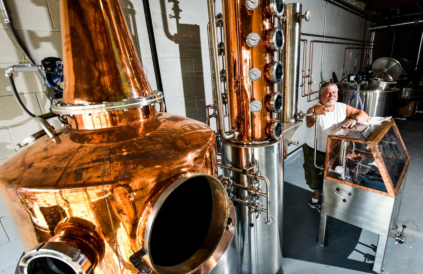 Mike Dranschak stands by the still inside White Dog Distilling Company Thursday, Sept. 20 on Central Avenue in Middletown. He is currently renovating the space formerly occupied by Liberty Spirits to feature a larger bar and tasting area. 