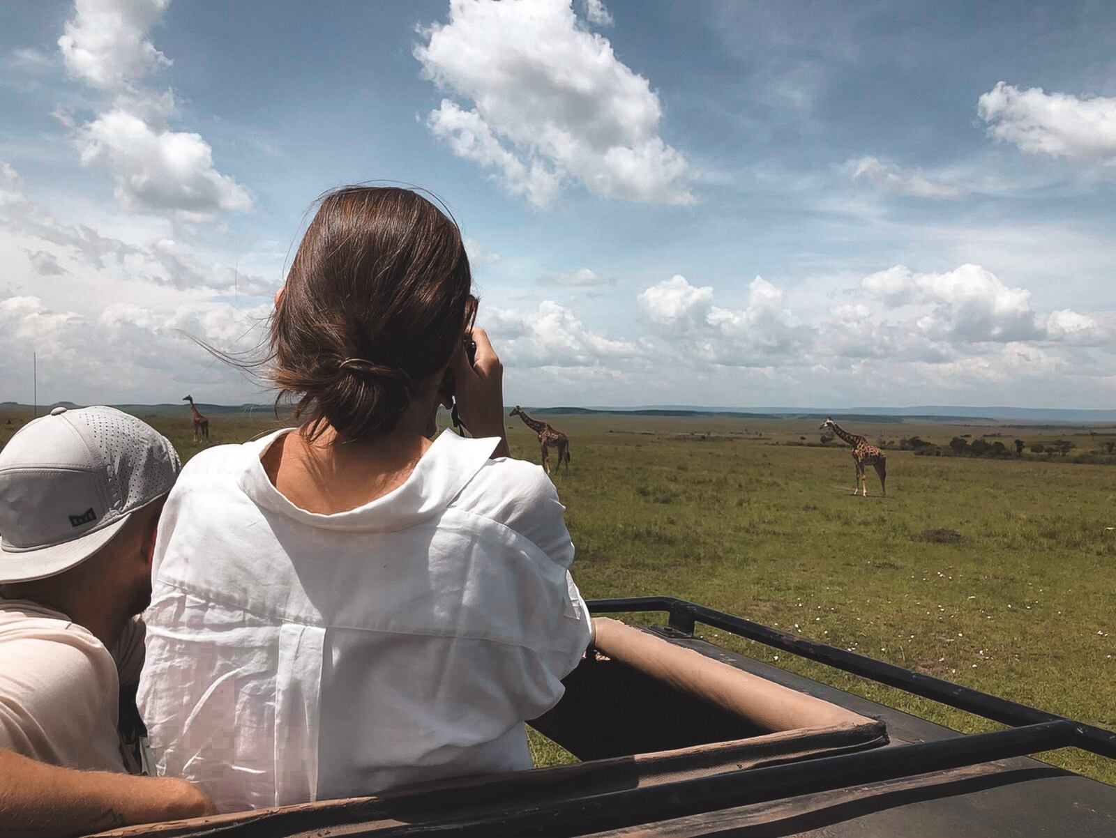 With Ian next to her, Lesli Dean photographs giraffes during a safari at the Maasai Mara National Reserve in Kenya. Lesli Dean/CONTRIBUTED