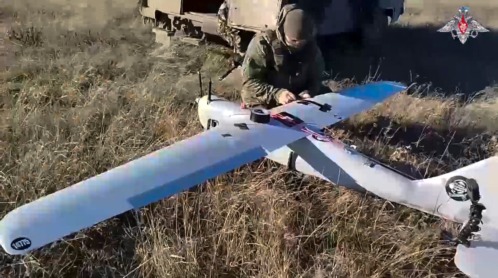 In this photo taken from video distributed by Russian Defense Ministry Press Service on Sunday, Jan. 26, 2025, a Russian serviceman prepares a "Orlan-10" drone in an undisclosed location in Ukraine. (Russian Defense Ministry Press Service via AP)