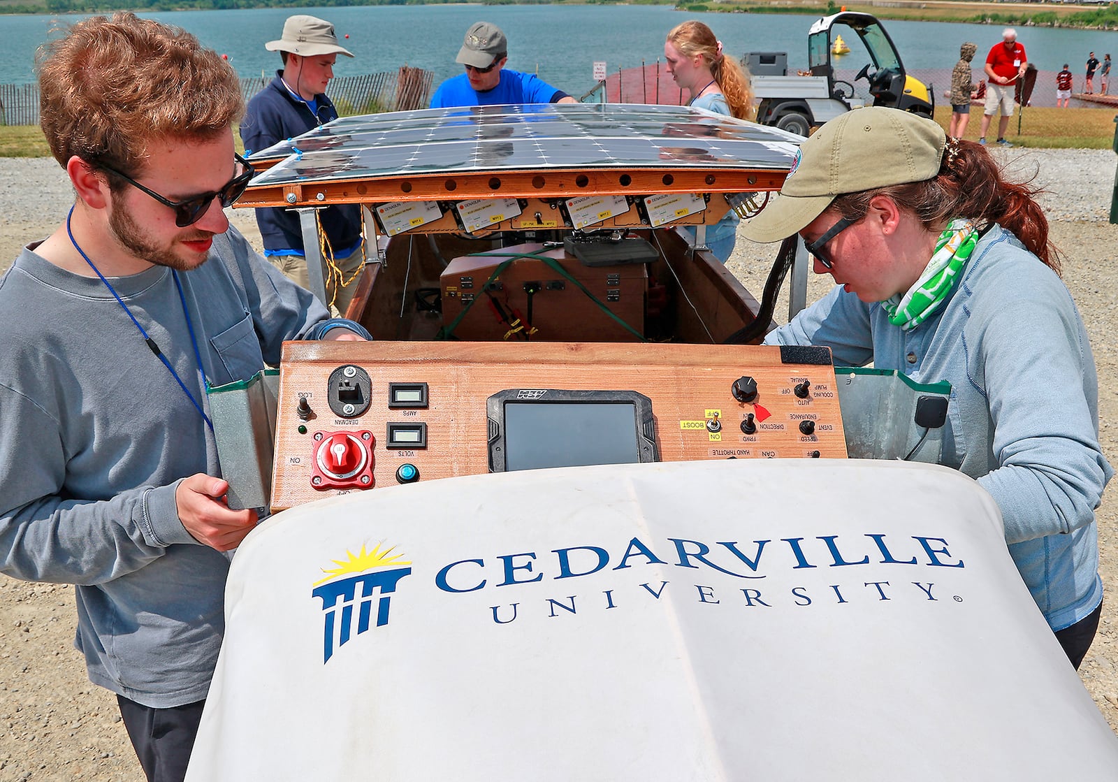 Members of the Cedarville University SOLAR SPLASH team, Asa Mudd (left) and Ruth Lessen work on their boat before a race Thursday, June 8, 2023. BILL LACKEY/STAFF