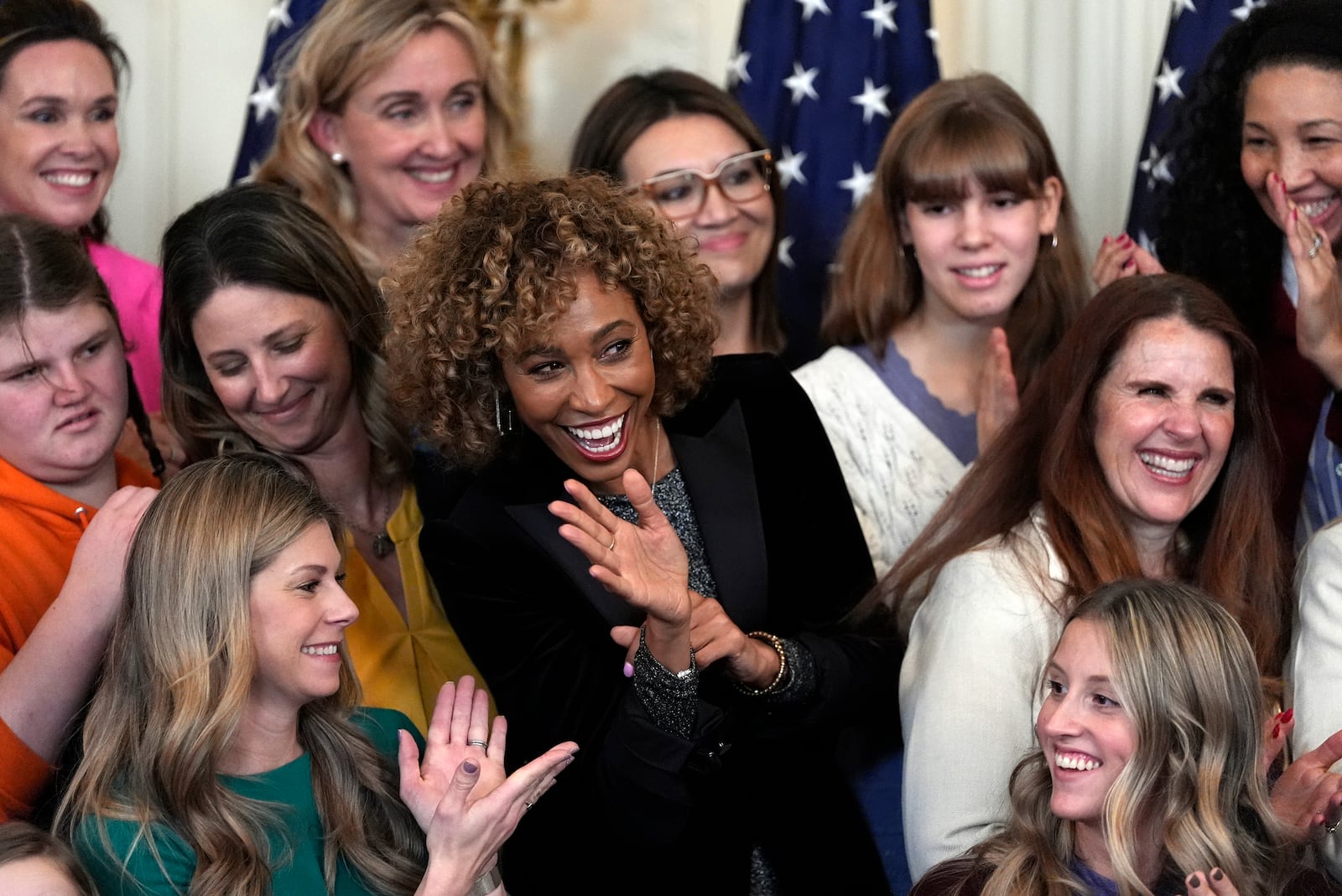 Sage Steele waves as President Donald Trump speaks before signing an executive order barring transgender female athletes from competing in women's or girls' sporting events, in the East Room of the White House, Wednesday, Feb. 5, 2025, in Washington. (AP Photo/Alex Brandon)