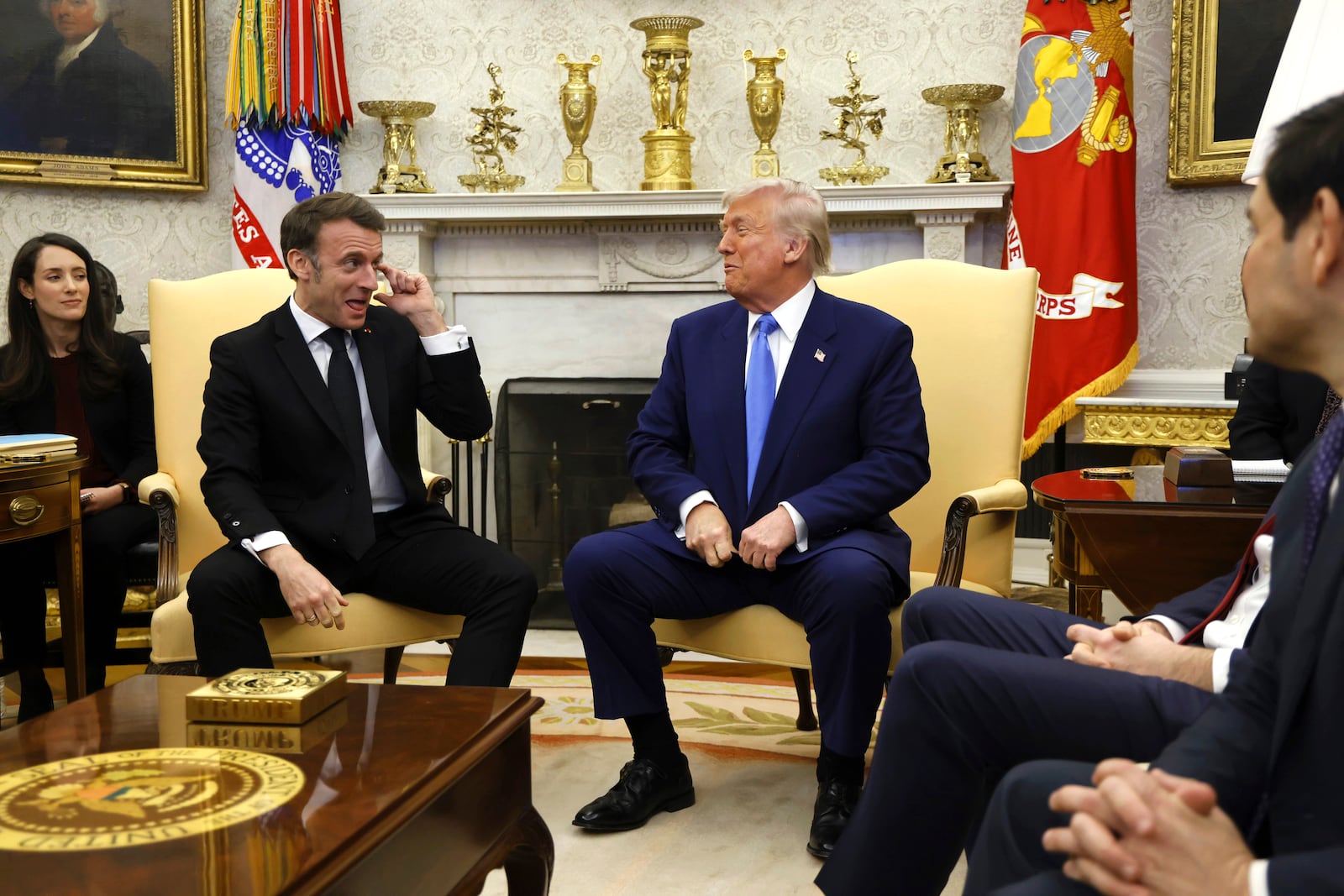 President Donald Trump, center right, and France's President Emmanuel Macron, center left, speak during a meeting in the Oval Office of the White House in Washington, Monday, Feb. 24, 2025. (Ludovic Marin/Pool via AP)