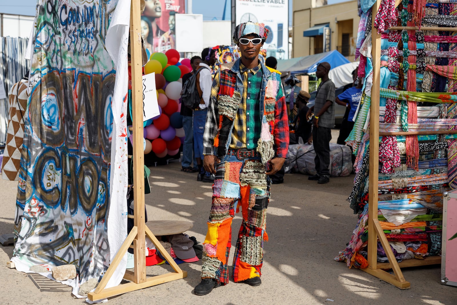 A man dressed in an upcycled outfit poses for a photograph during a thrift and an upcycle show in Accra, Ghana, Sunday, Oct. 27, 2024. (AP Photo/Misper Apawu)