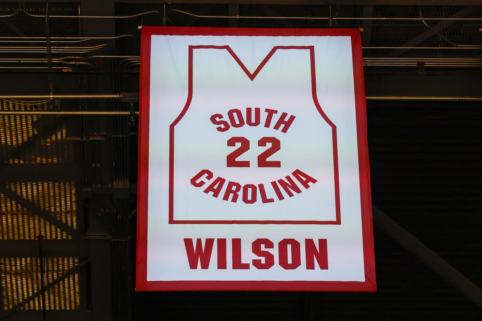 A'ja Wilson, center, stands with her parents Eva and Roscoe Wilson as they watch her number be retired during a ceremony before an NCAA college basketball game between South Carolina and Auburn in Columbia, S.C., Sunday, Feb. 2, 2025. (AP Photo/Nell Redmond)