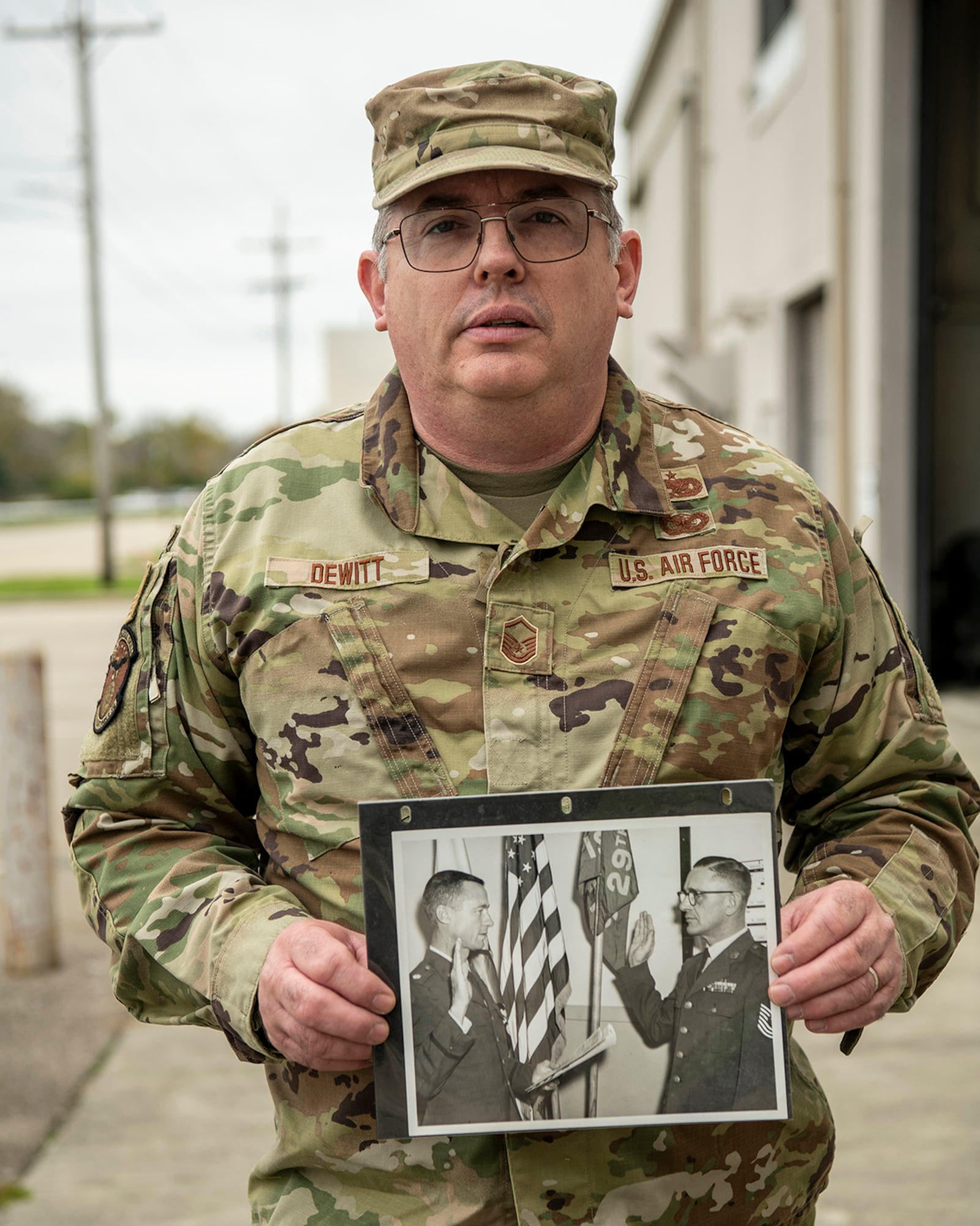 Master Sgt. Raymond DeWitt Jr. displays a photo of his father, Master Sgt. Raymond DeWitt Sr. U.S. AIR FORCE PHOTO/MASTER SGT. PATRICK O’REILLY